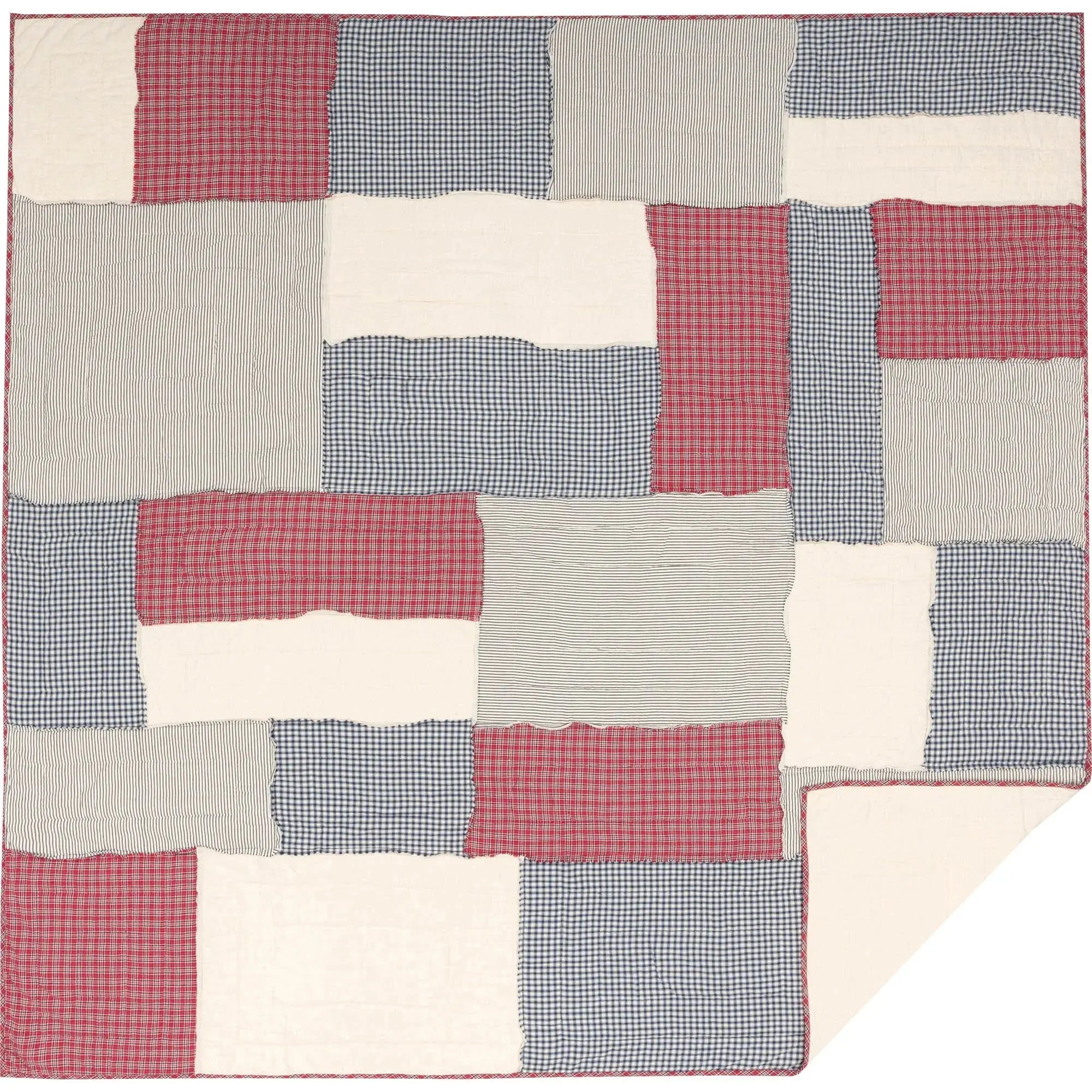 Red, blue, and cream patchwork quilt with gingham and stripe patterns, cozy farmhouse decor