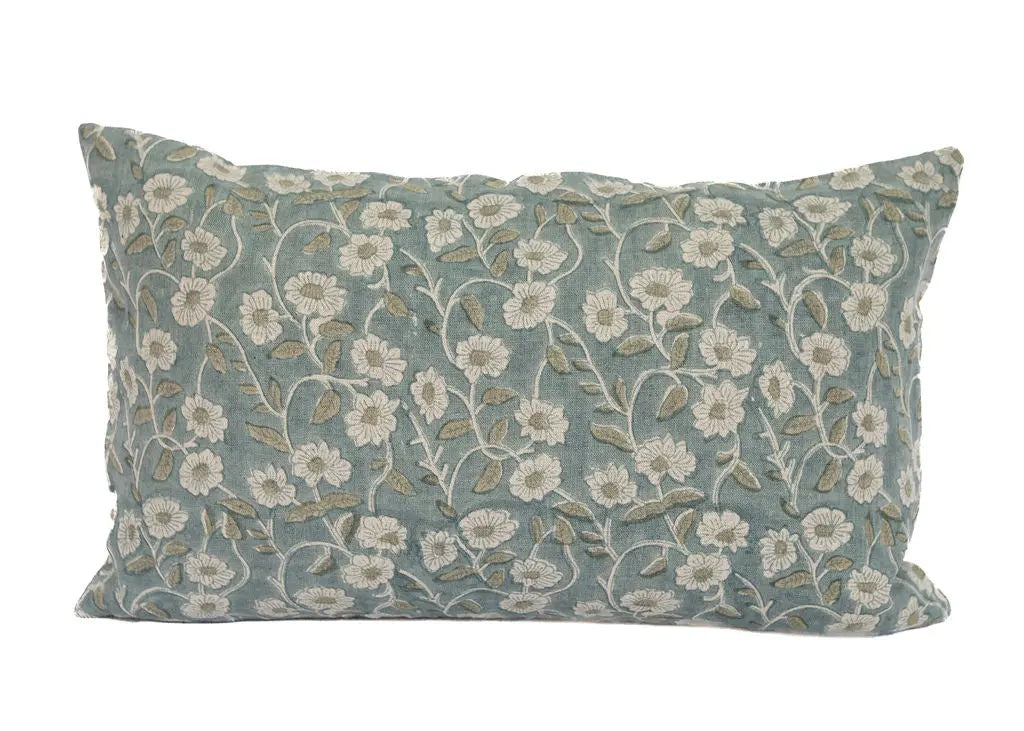 Decorative pillow with floral pattern on a light blue background