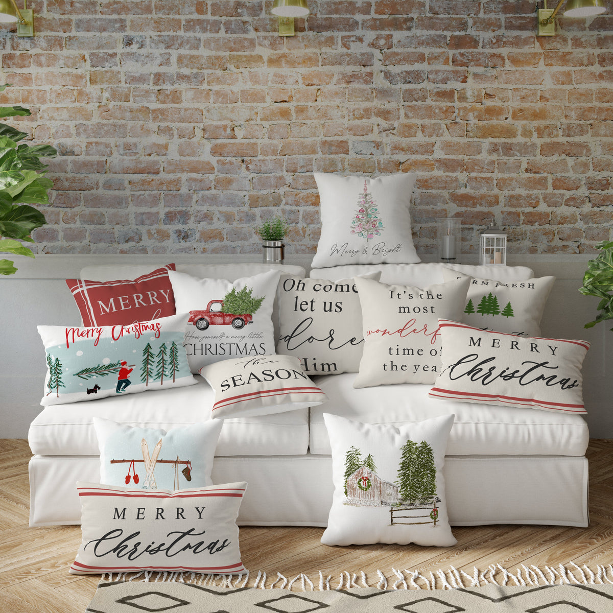 Decorative Christmas pillows on a sofa against a brick wall.