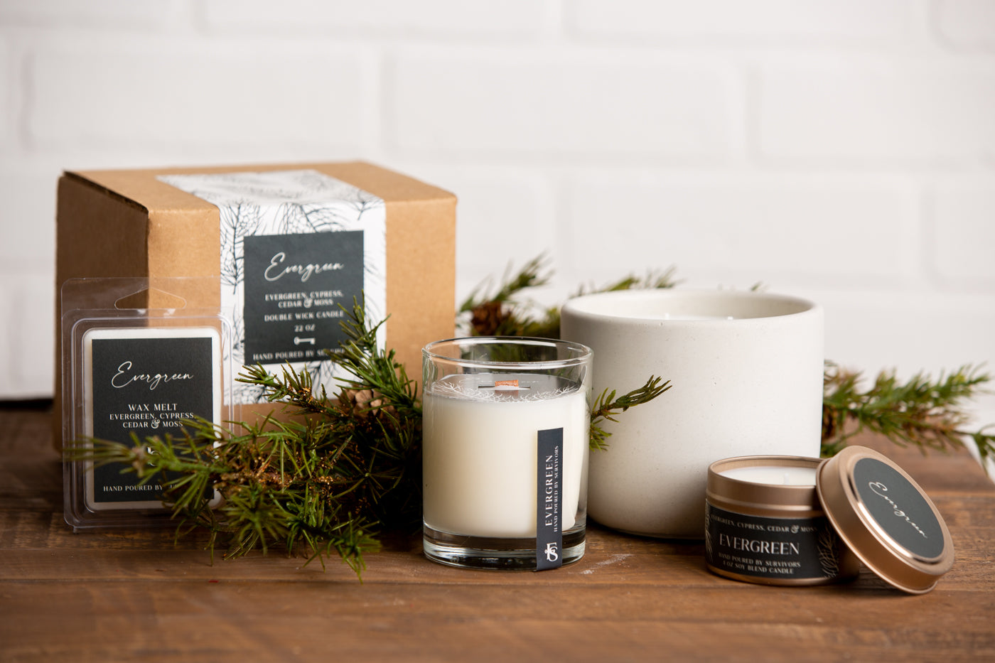 Collection of candles and packaging on a wooden surface with a white background