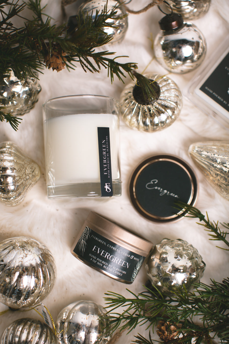 Candle and decorative items with 'Evergreen' branding on a light background