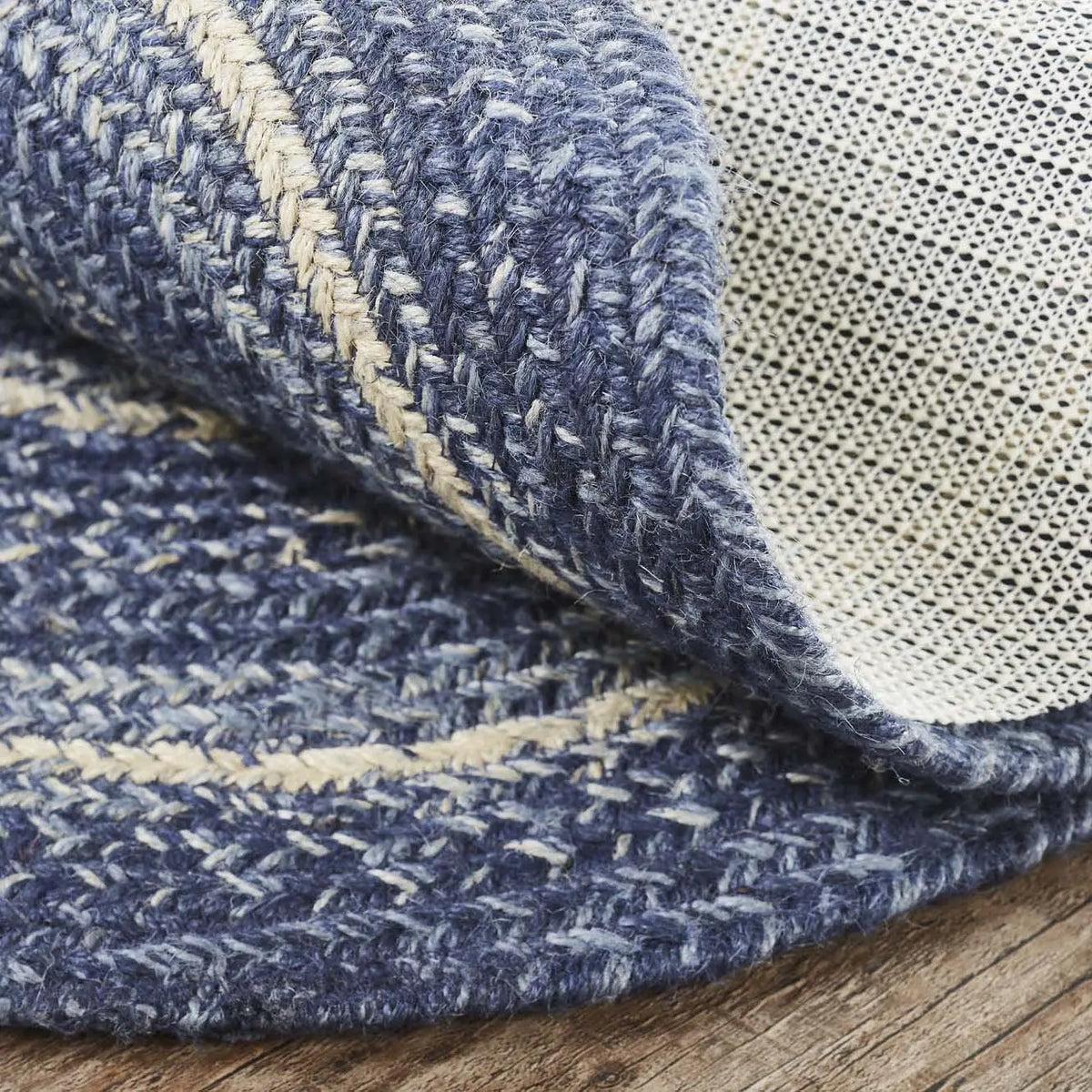Close-up of textured blue and beige fabric on a wooden surface