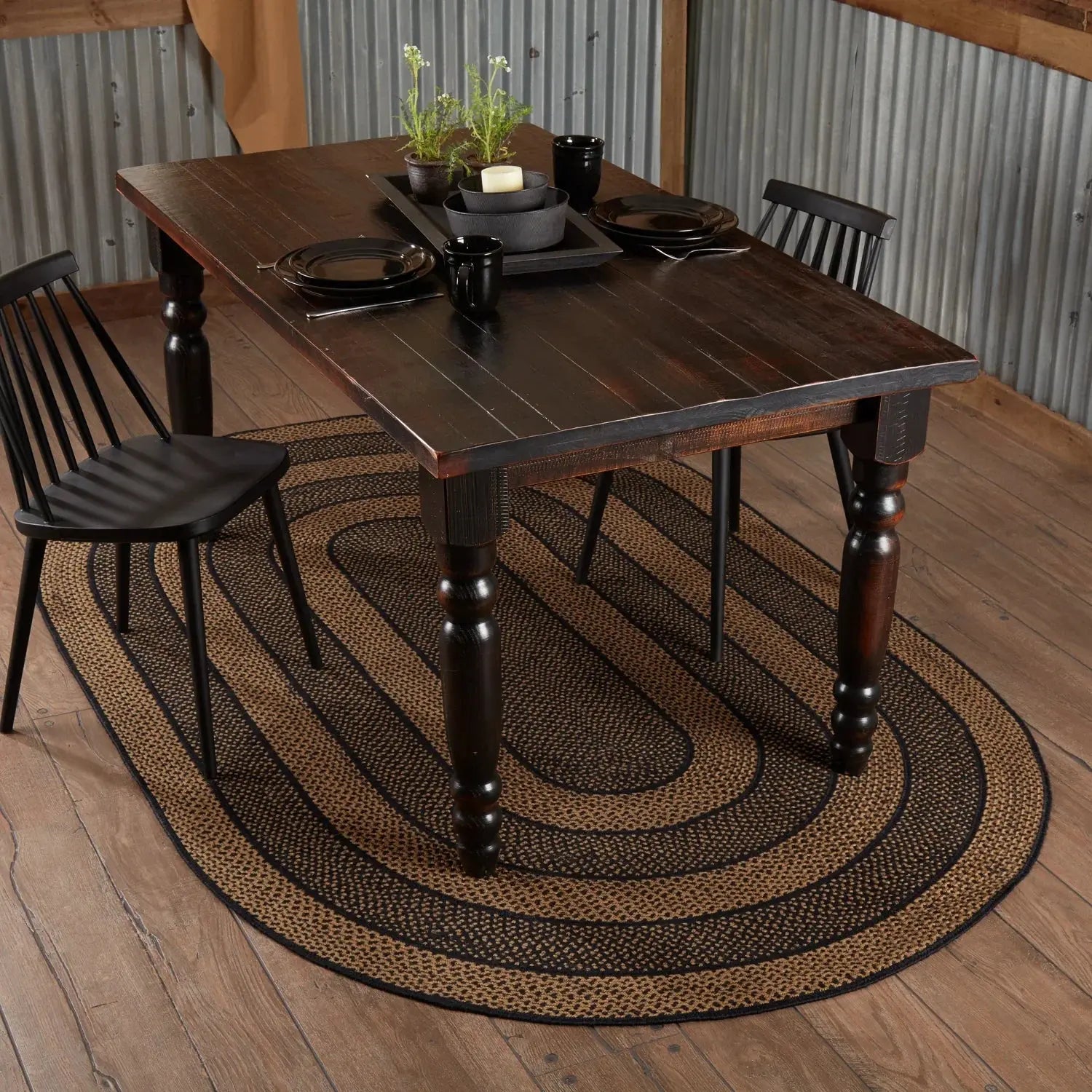 Wooden dining table with chairs on a wooden floor and rug