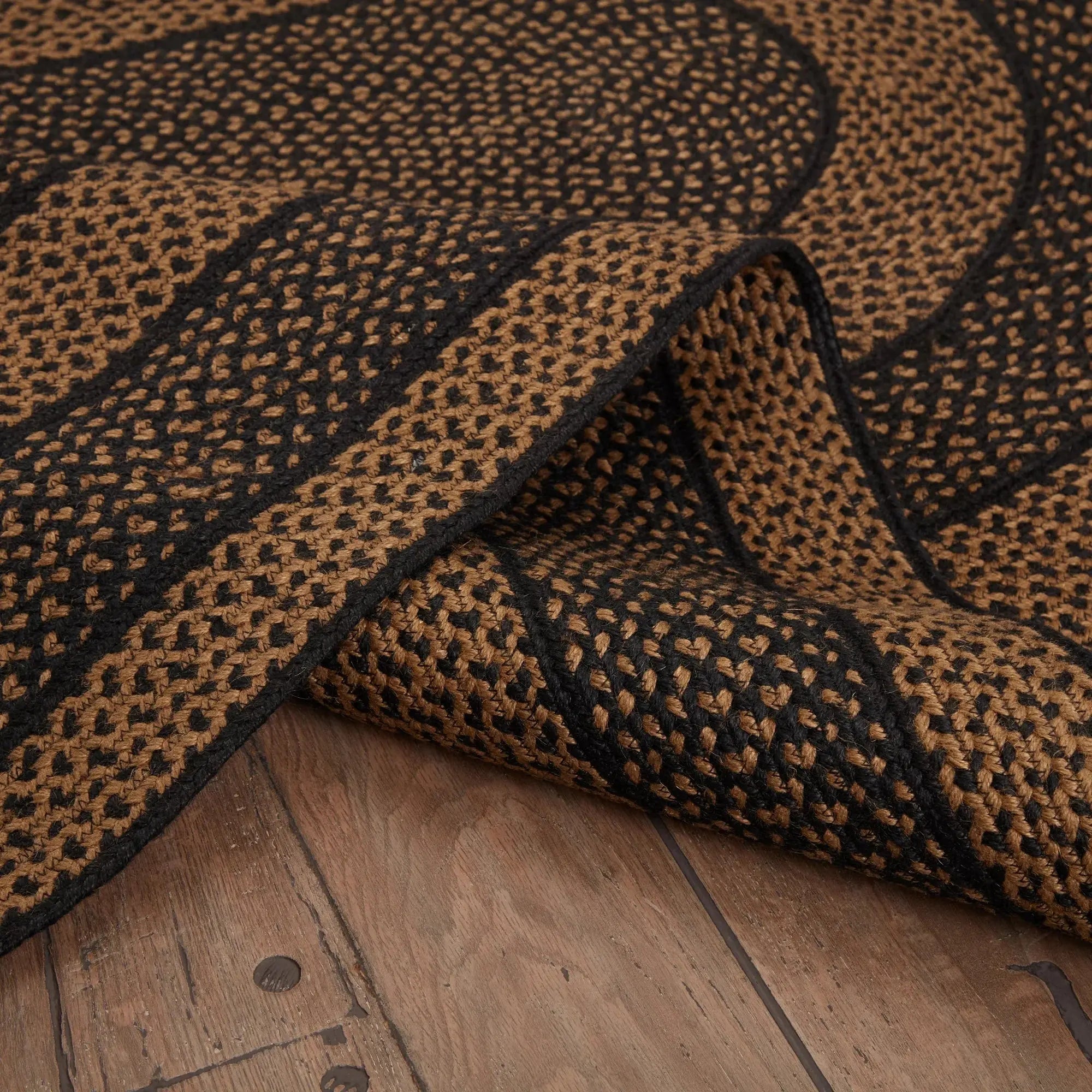 Brown and black patterned rug on a wooden floor