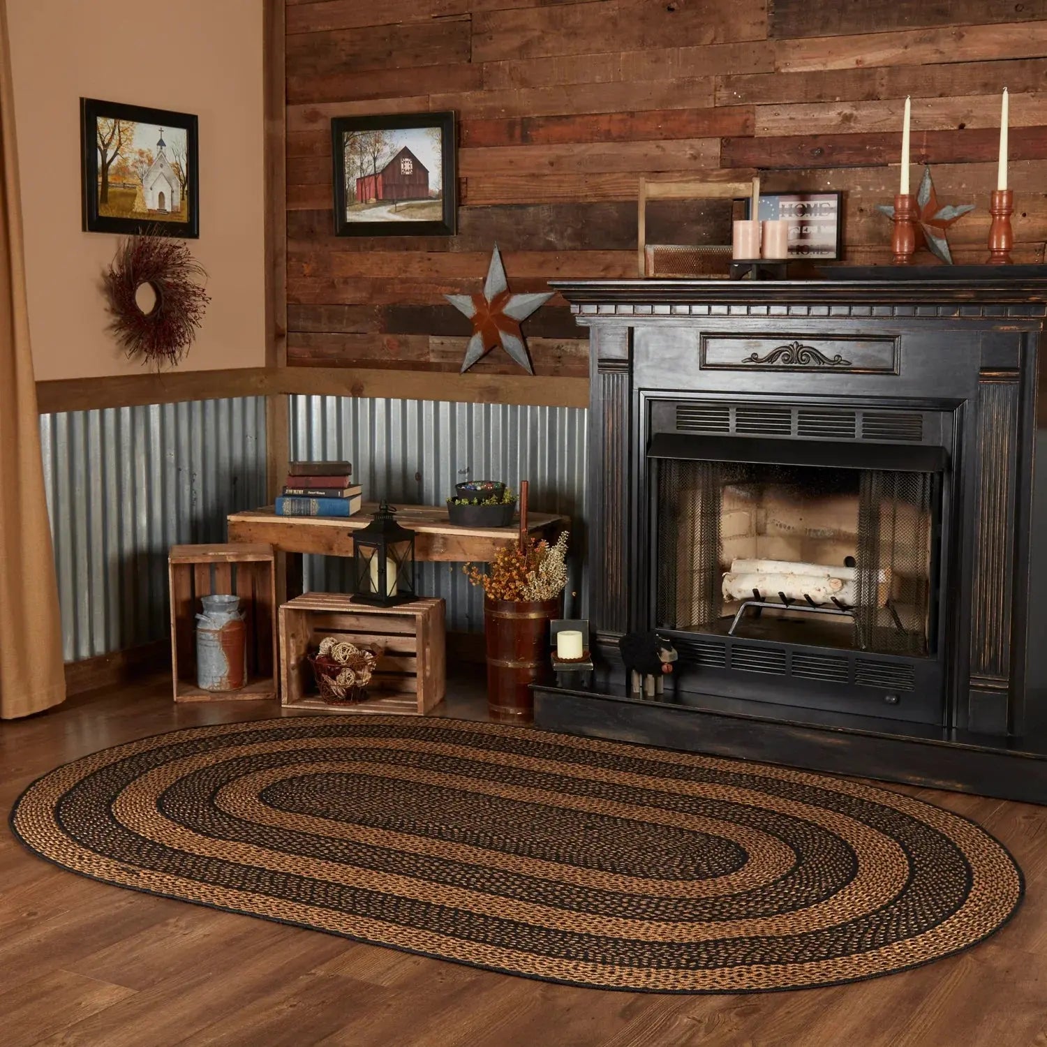 Cozy living room with a fireplace, wooden walls, and a braided rug.
