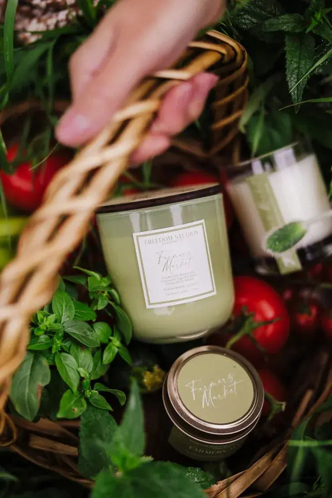 Farmers Market scented candles in wicker basket with fresh herbs and tomatoes, cozy farmhouse decor