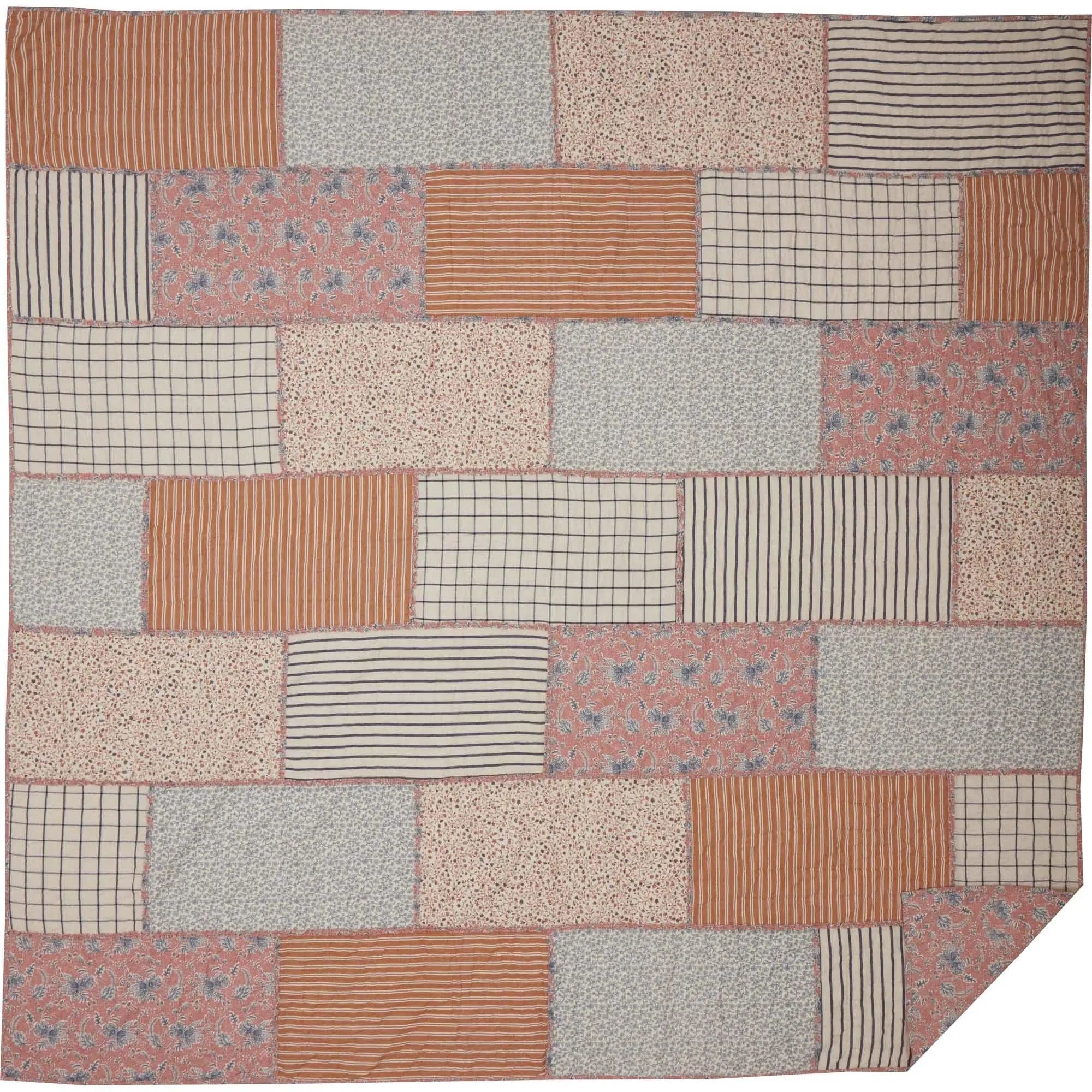Cozy patchwork quilt with farmhouse patterns in rust, cream, and blue for cottage-style home decor