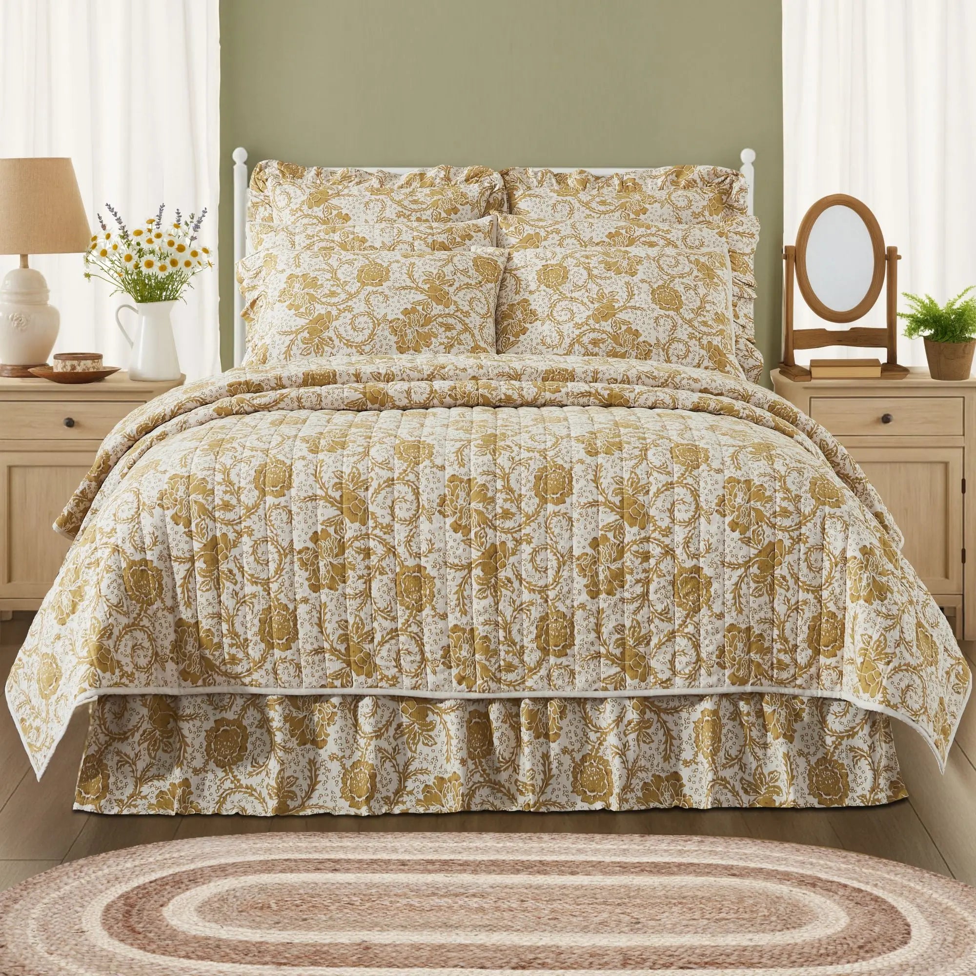 Floral patterned bedspread on a bed in a bedroom setting with lamps and decor.
