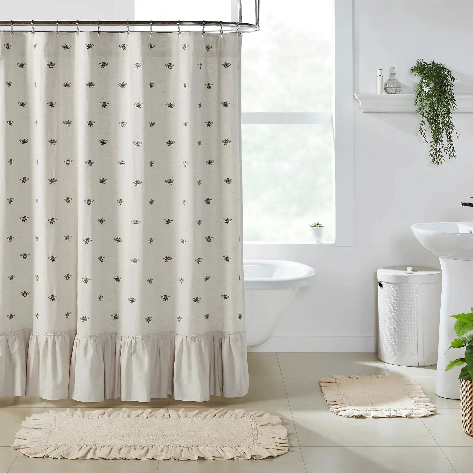 Bathroom with a white shower curtain featuring black heart patterns, a sink, and a rug.