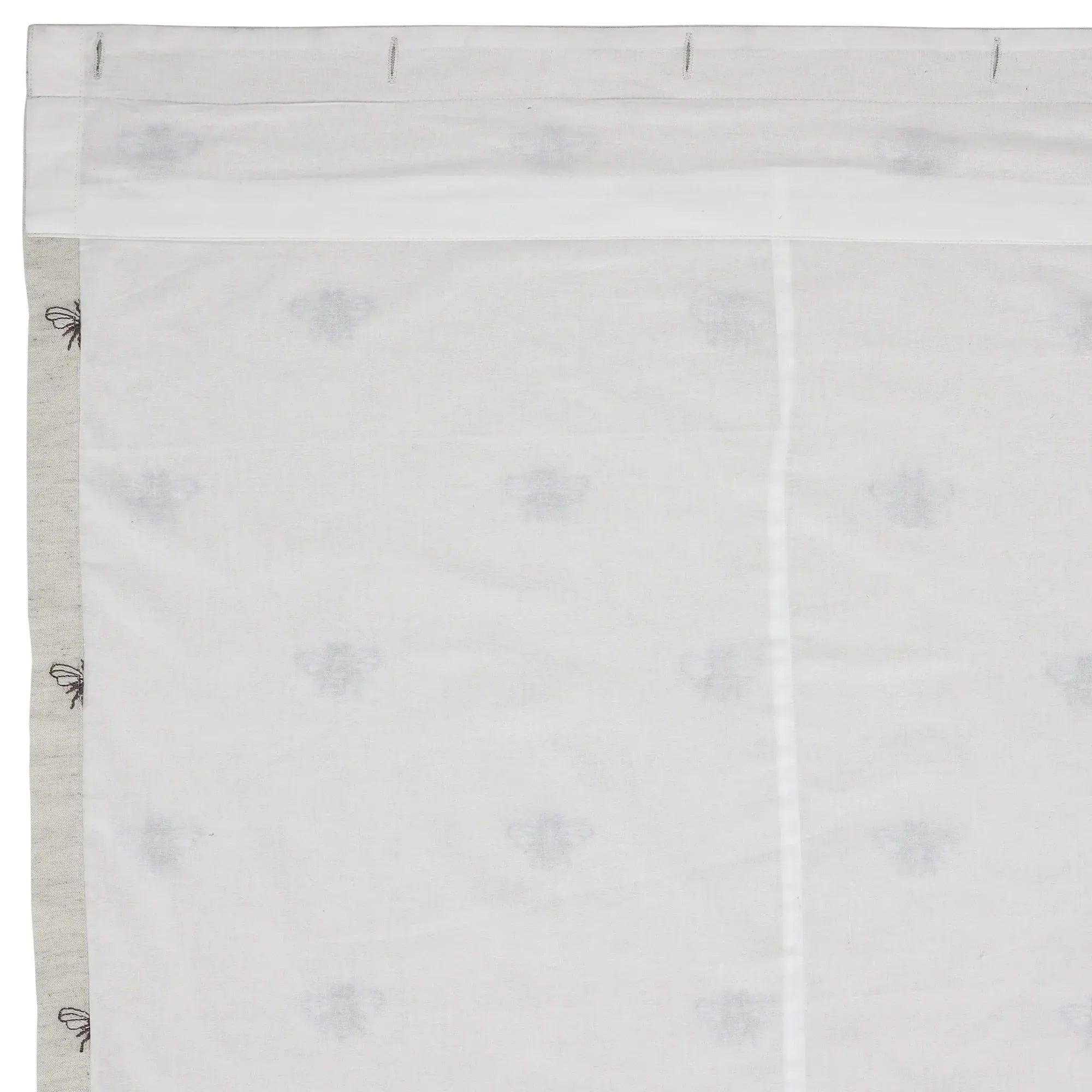 White fabric with gray border and small black floral patterns on a white background
