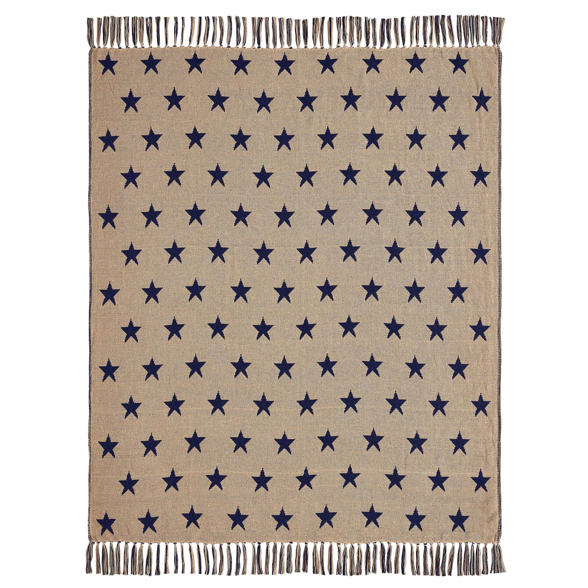 Beige blanket with navy blue star pattern on a white background
