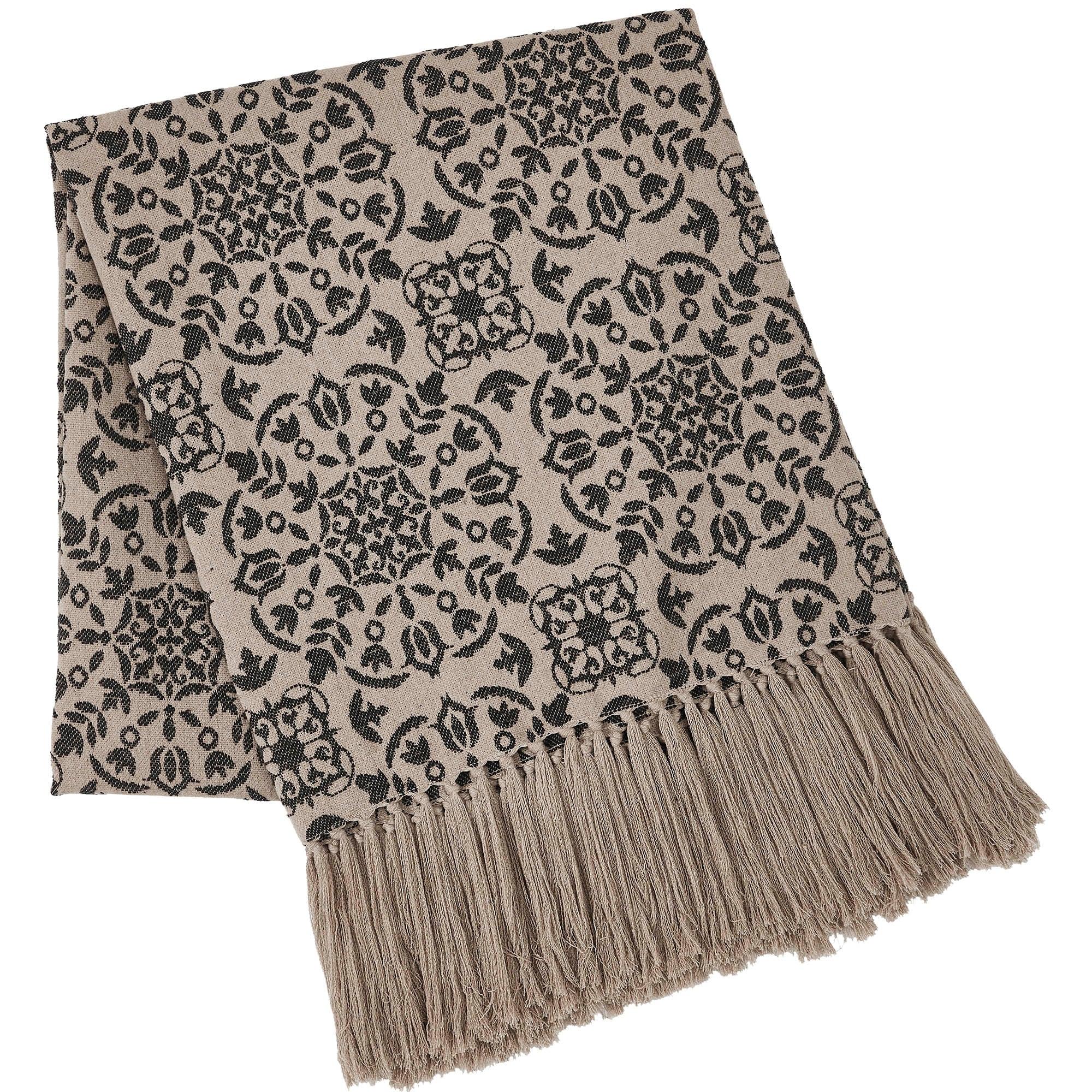 Beige throw blanket with black floral damask pattern and tassels, cozy farmhouse decor