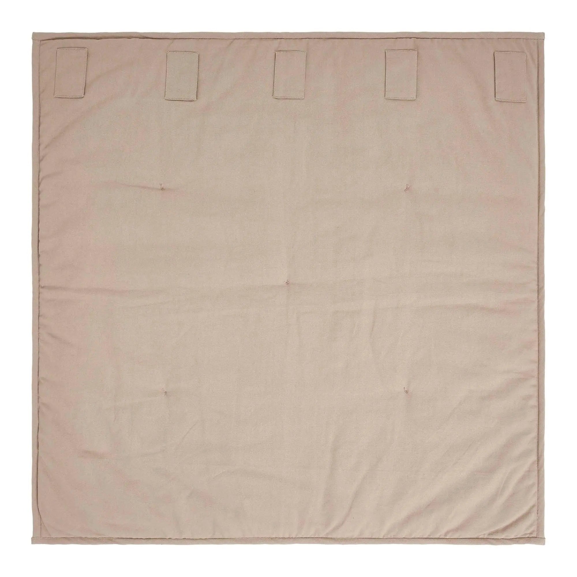 Beige quilt with button closures on a white background