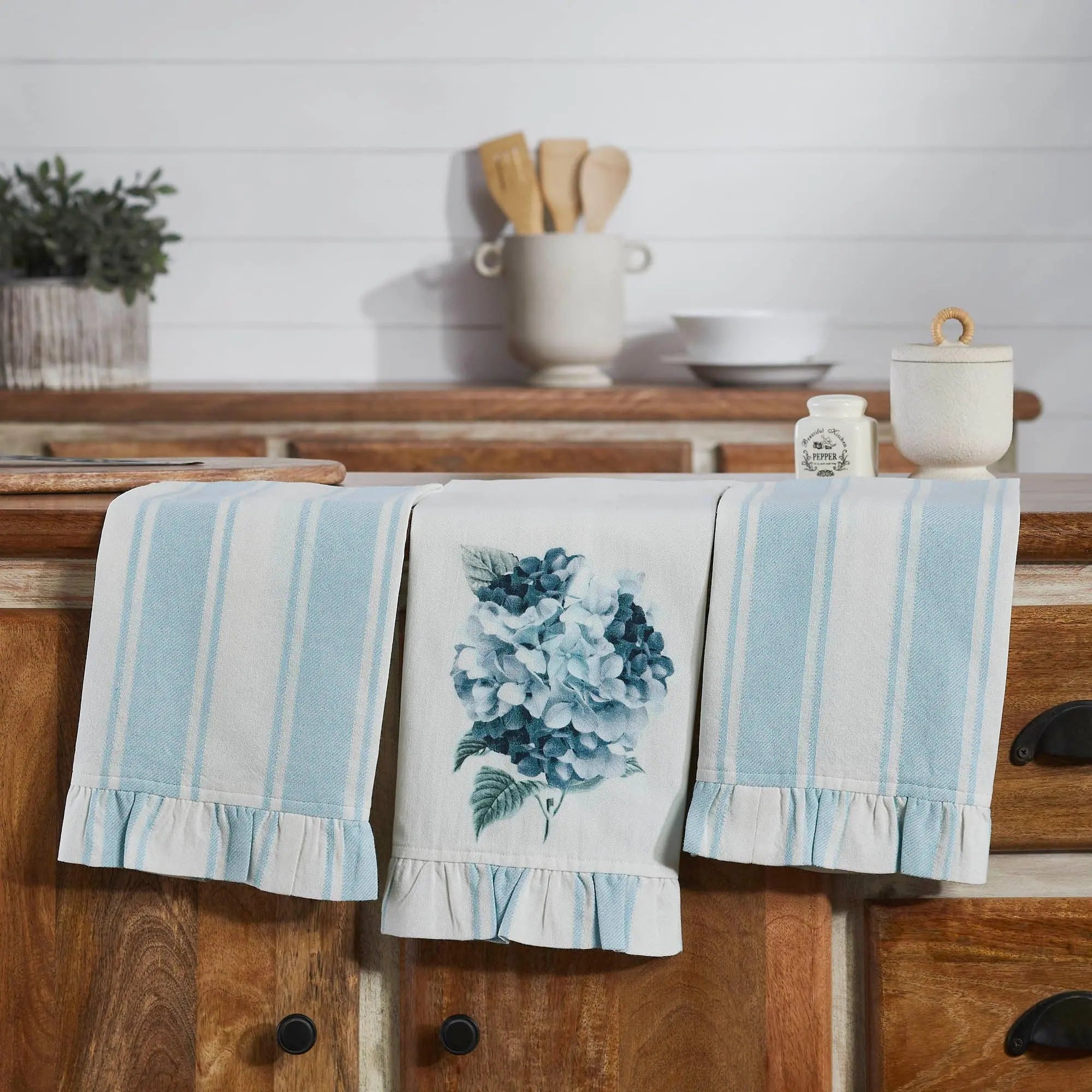 Kitchen towel with floral design hanging on a wooden cabinet