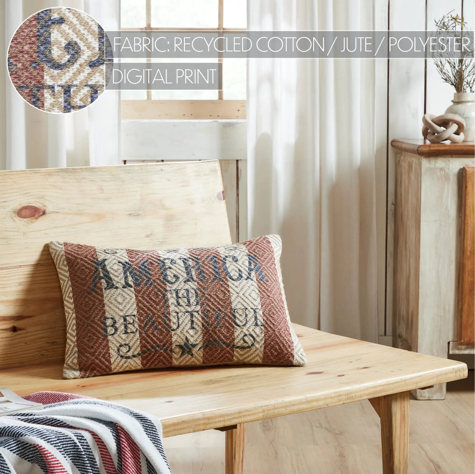 Decorative pillow with 'America the Beautiful' text on a wooden bench in a home setting.