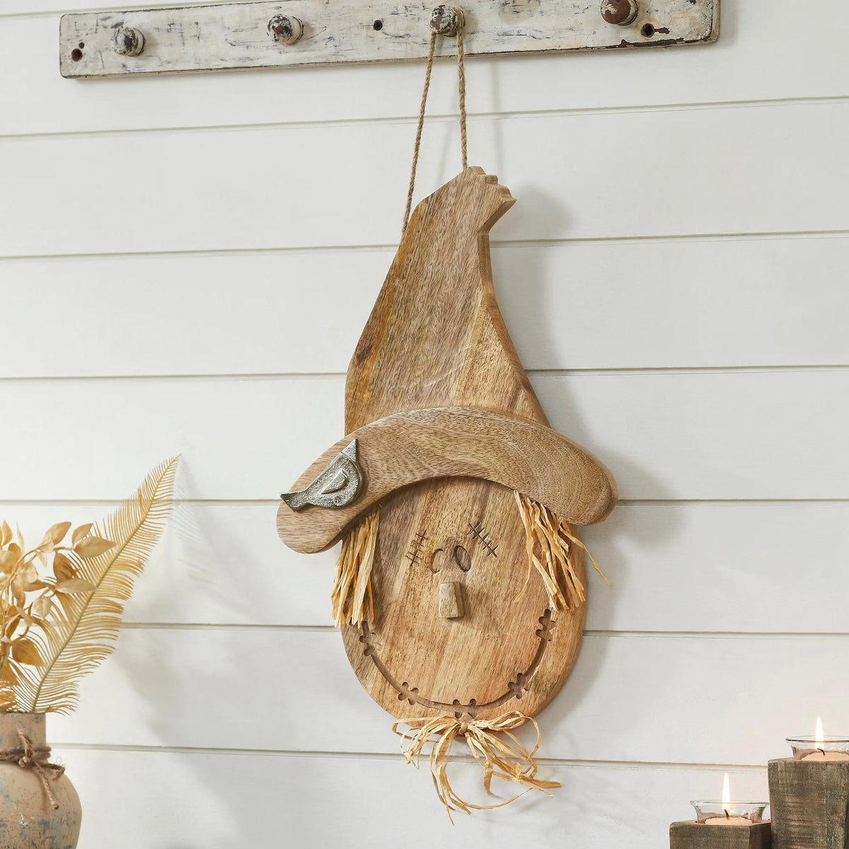 Wooden gnome wall decoration on a white wooden wall