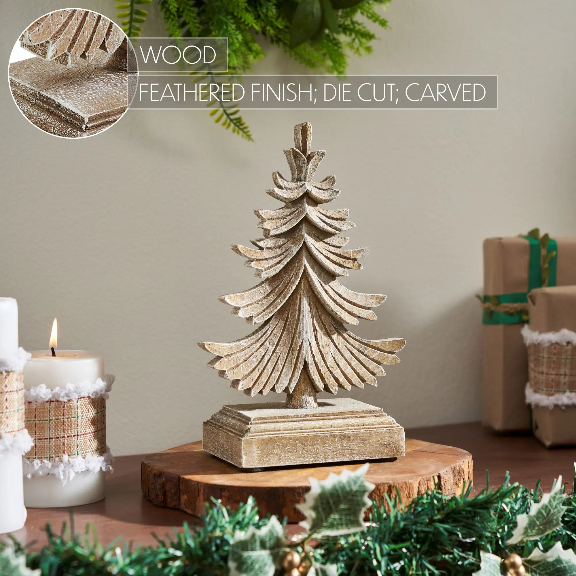 Wooden Christmas tree decoration on a table with candles and gift boxes in the background.