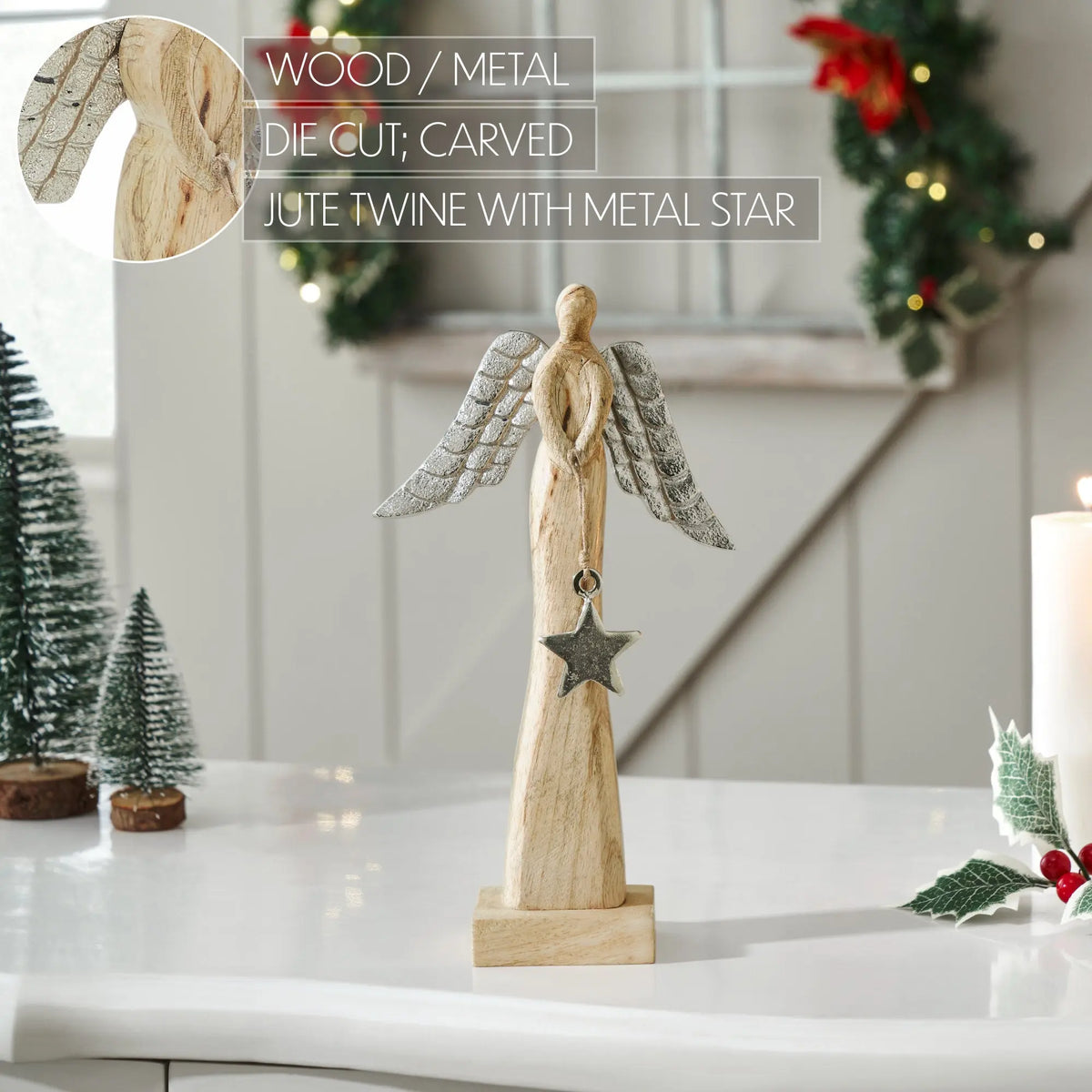 A carved wooden angel figurine with gray jute wings and a hanging metal star, displayed on a white tabletop in a decorated indoor setting. Text overlays show product details and a close-up inset of the wood texture.