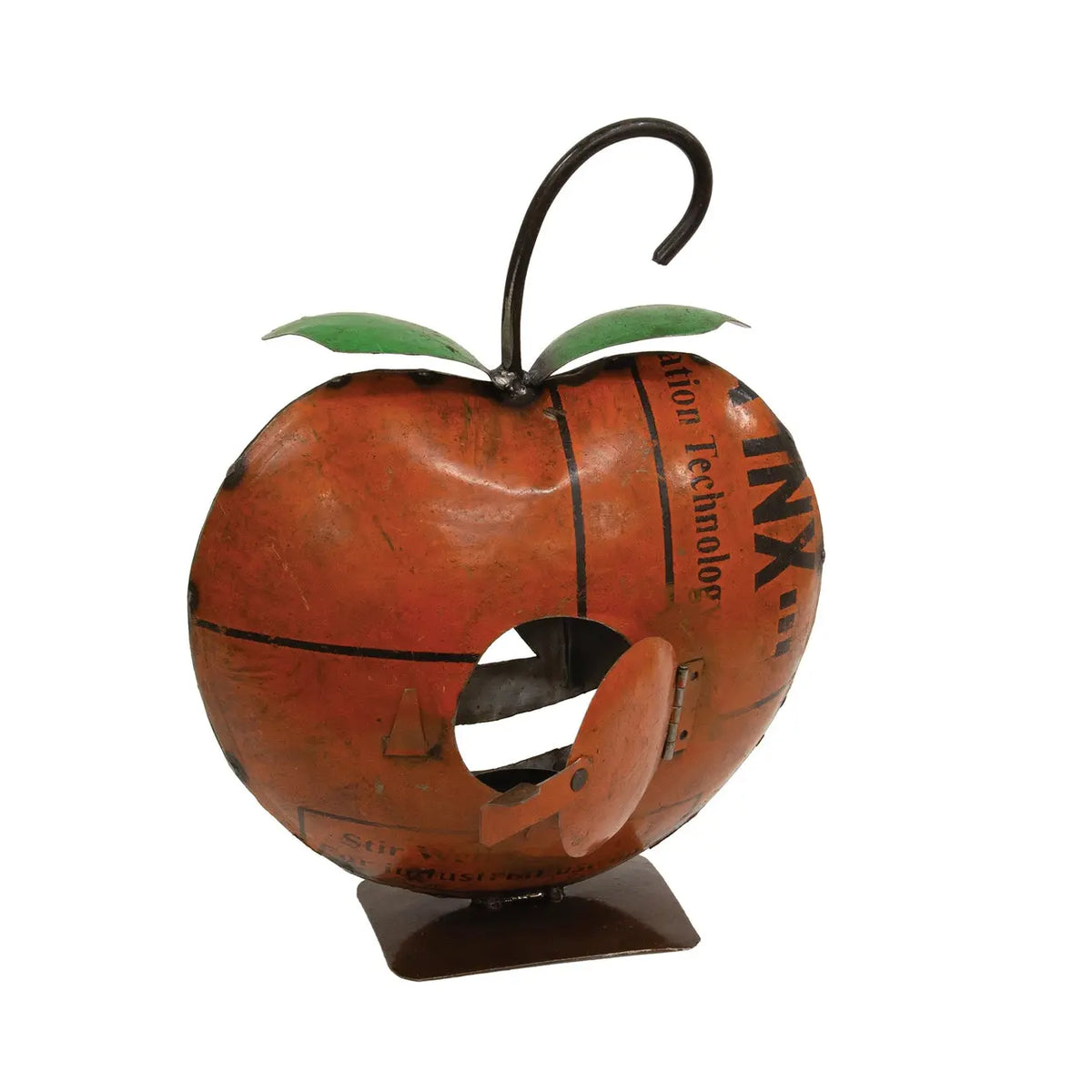 A decorative metal sculpture shaped like an apple, featuring a distressed orange-brown body with black printed text, green leaf accents, a dark metal hook stem, and a small brown base, shown on a plain white background.