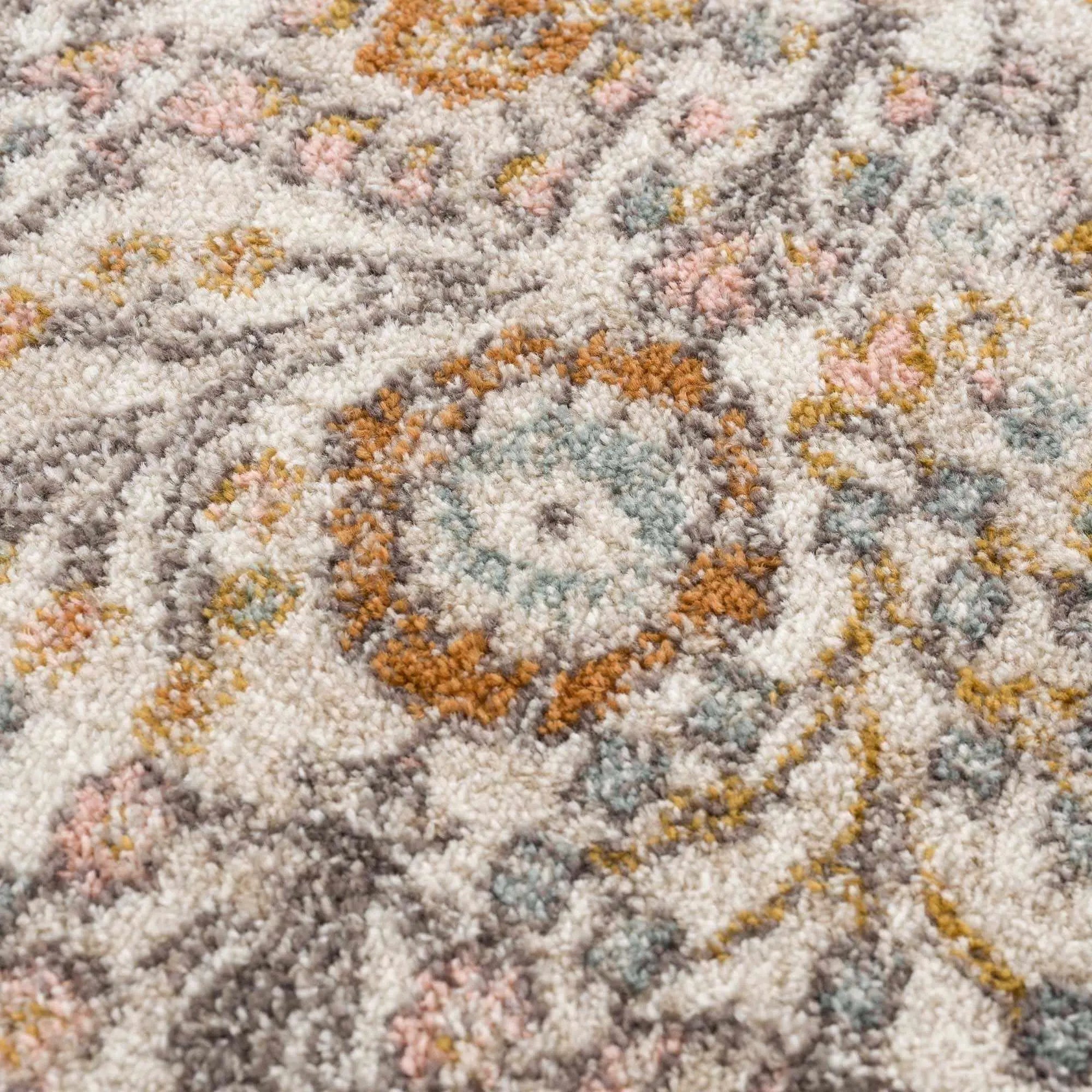 Cozy farmhouse style area rug with soft pastel floral pattern and textured weave for warm home decor