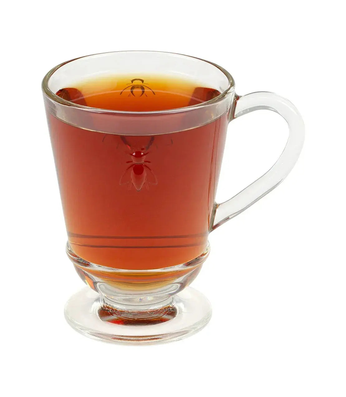Clear glass tea mug with bee design, filled with amber tea, cozy farmhouse decor