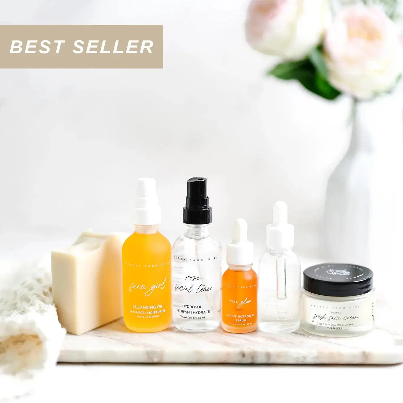 Best seller farmhouse skincare set with cleansing oil, toner, serum, and face cream on marble tray