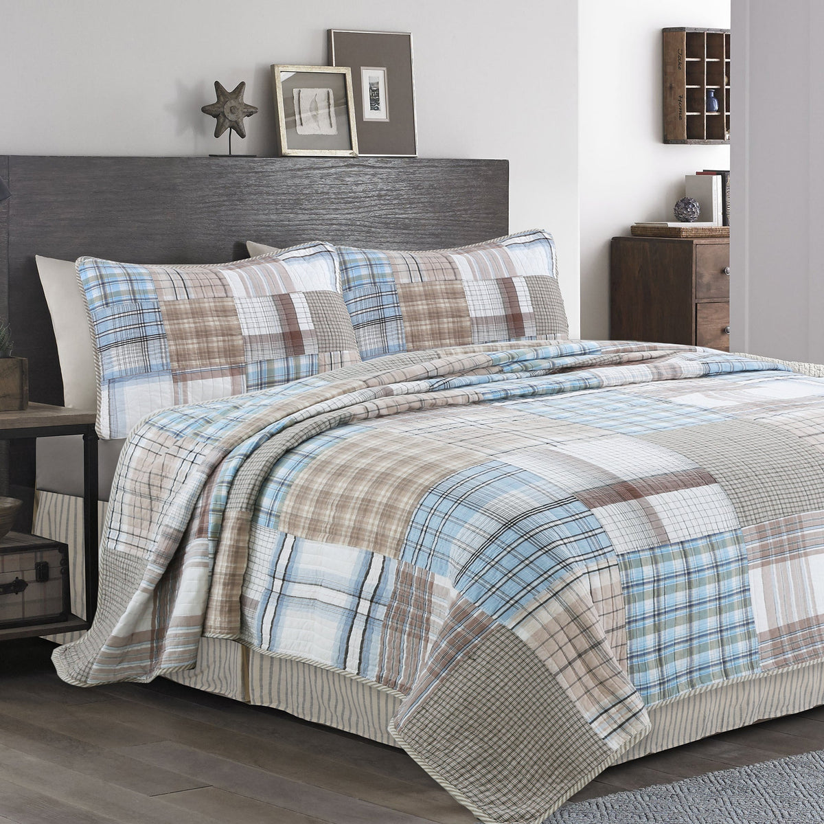 Plaid bedding set on a bed in a bedroom with wooden nightstands and decor.