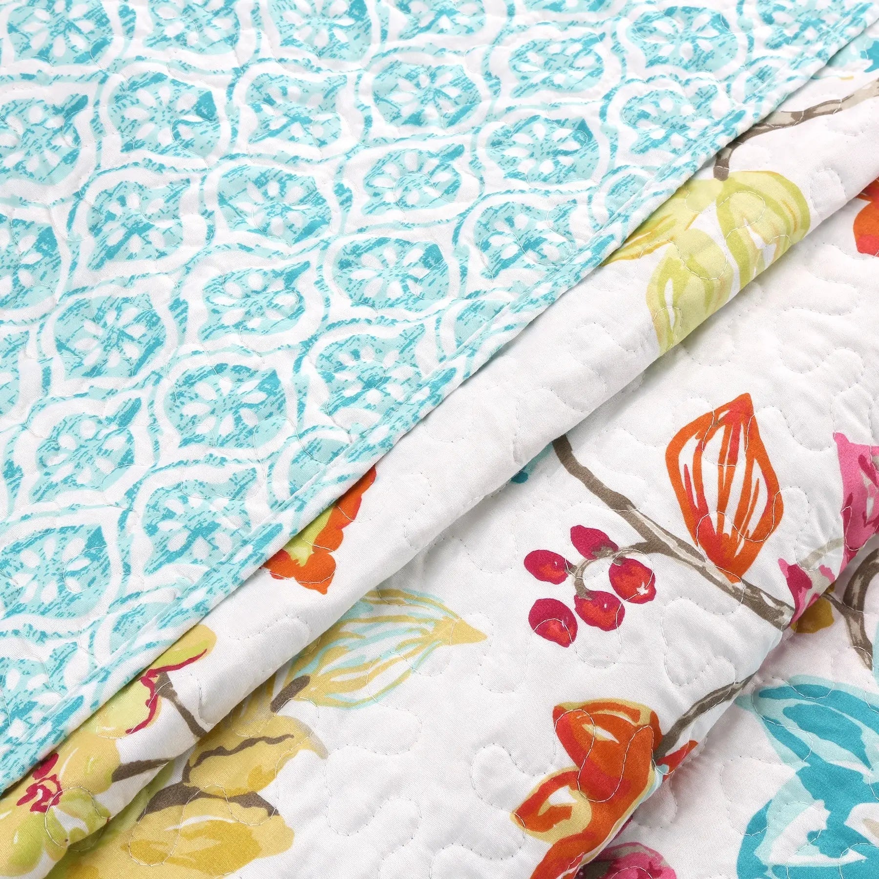 Tropical floral reversible quilt bedding set with colorful anemone garden print and matching shams for farmhouse, cottage, and coastal bedrooms.