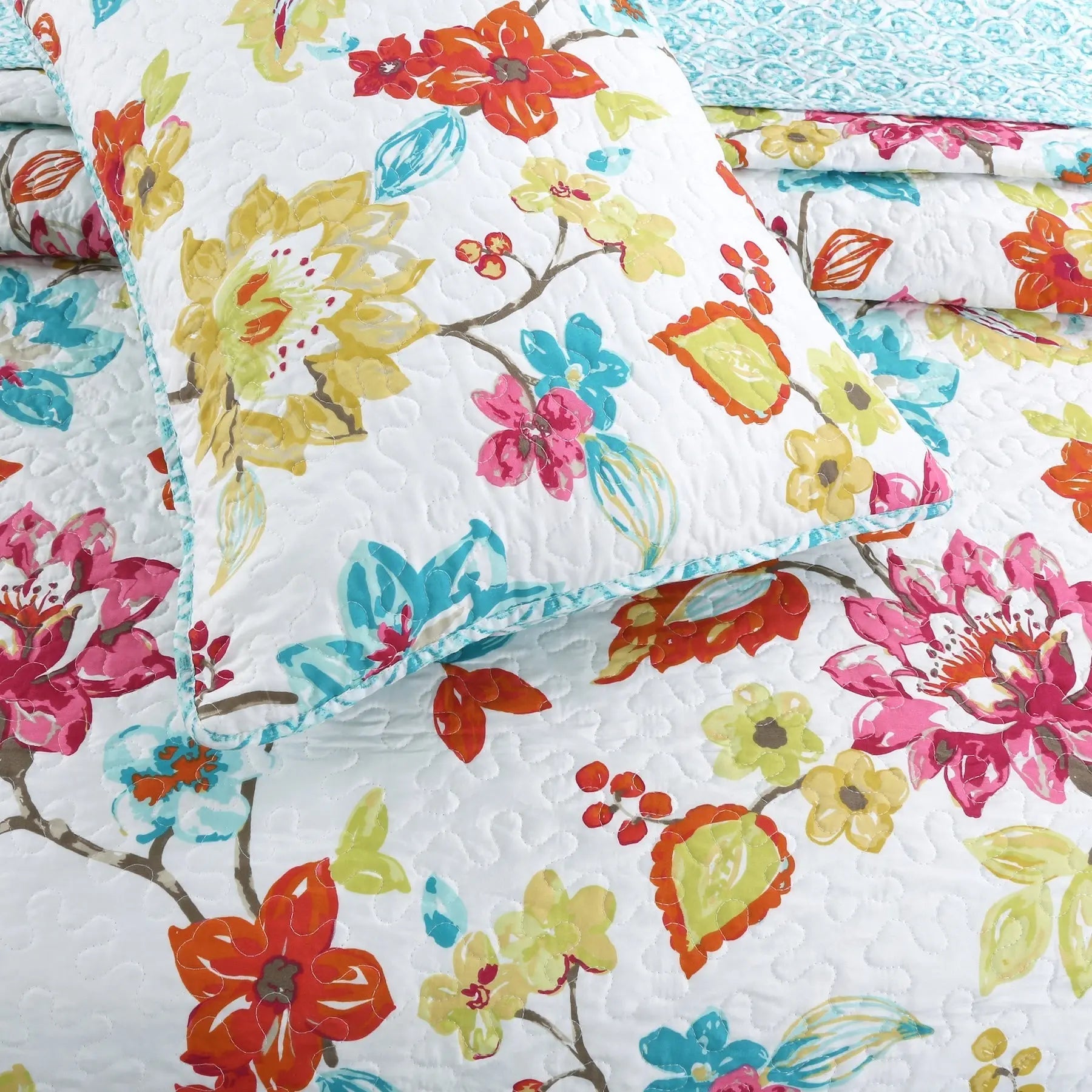 Tropical floral reversible quilt bedding set with colorful anemone garden print and matching shams for farmhouse, cottage, and coastal bedrooms.