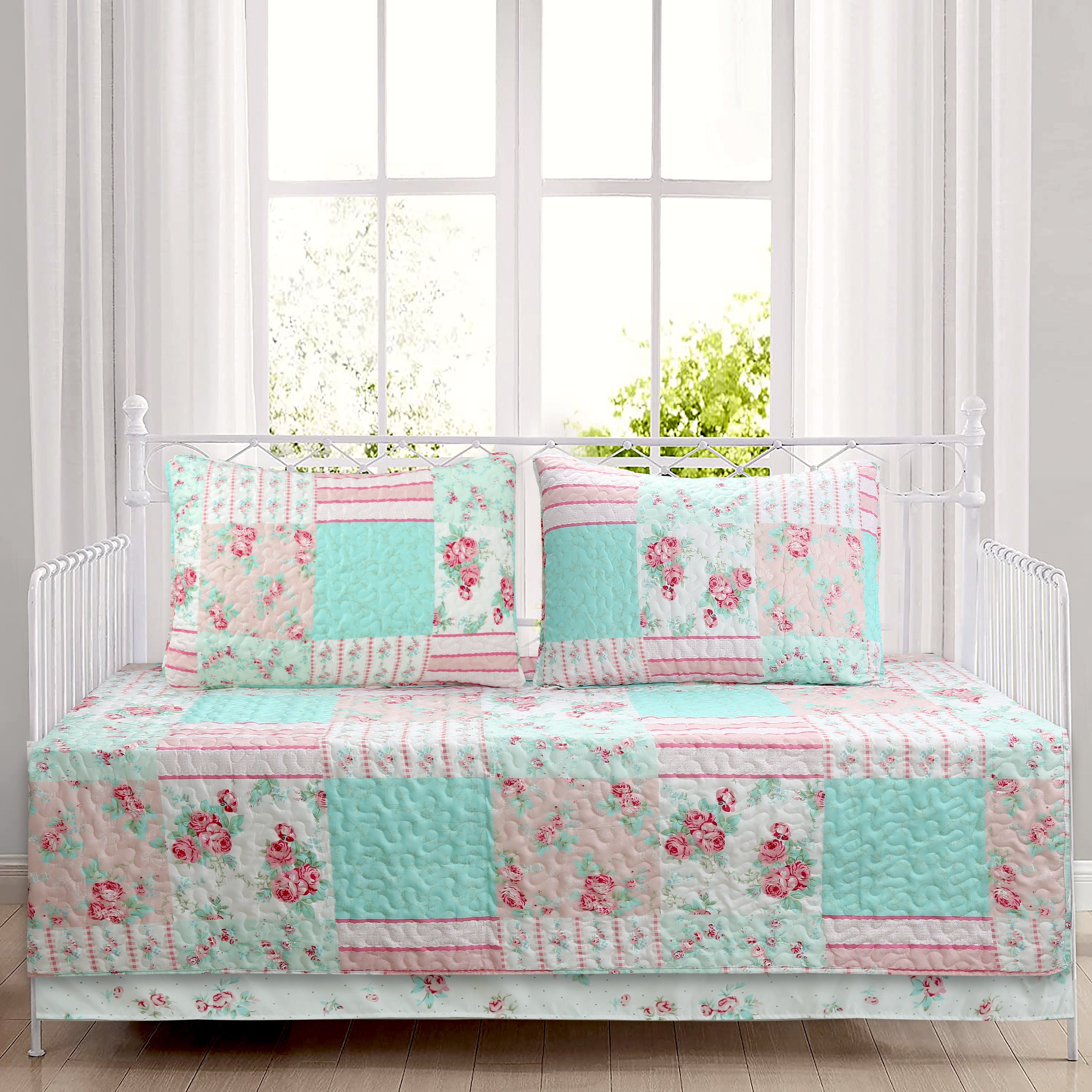 Tiffany Pink Blossom floral patchwork reversible daybed bedding set with pink floral quilt, matching shams, bed skirt, and decorative throw pillows in a cozy cottage bedroom.