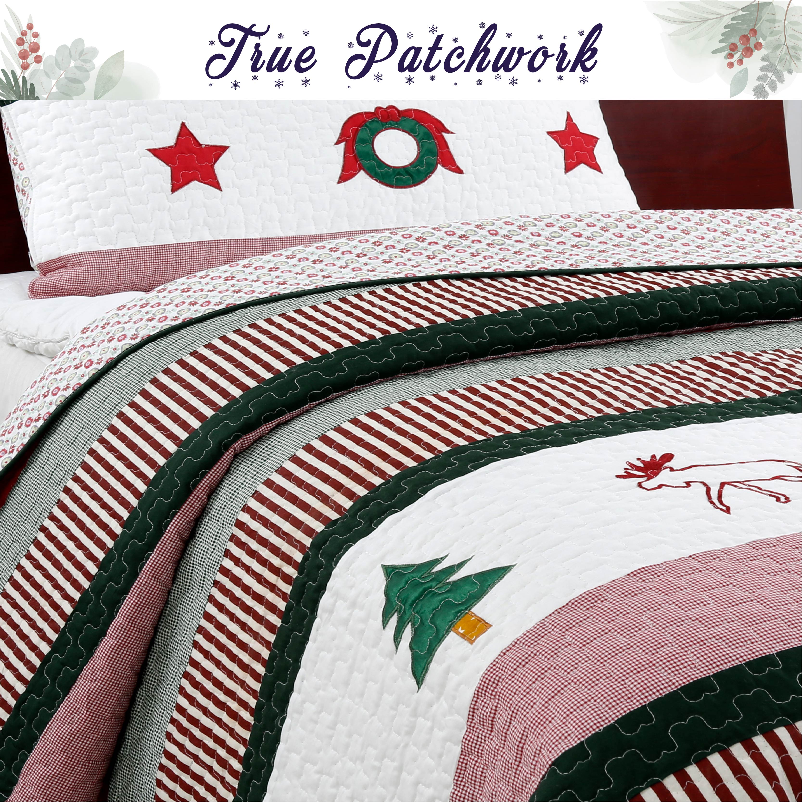 A Christmas-themed quilted bedding set featuring a white quilt with red and green stripes, a green wreath, red stars, a Christmas tree, and a reindeer, with a matching pillowcase and headboard.