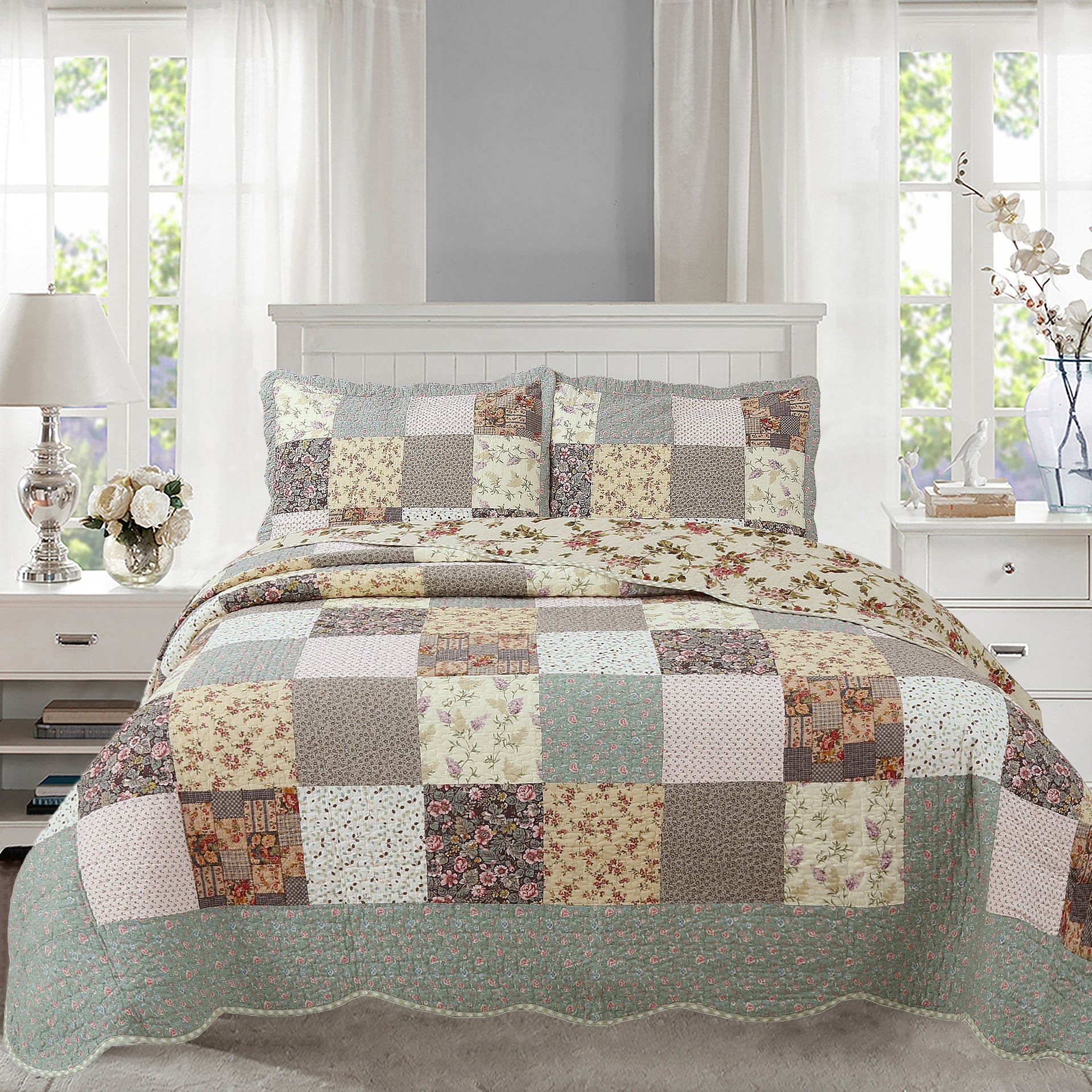 Patchwork quilt set on a bed in a bedroom with floral and geometric patterns.