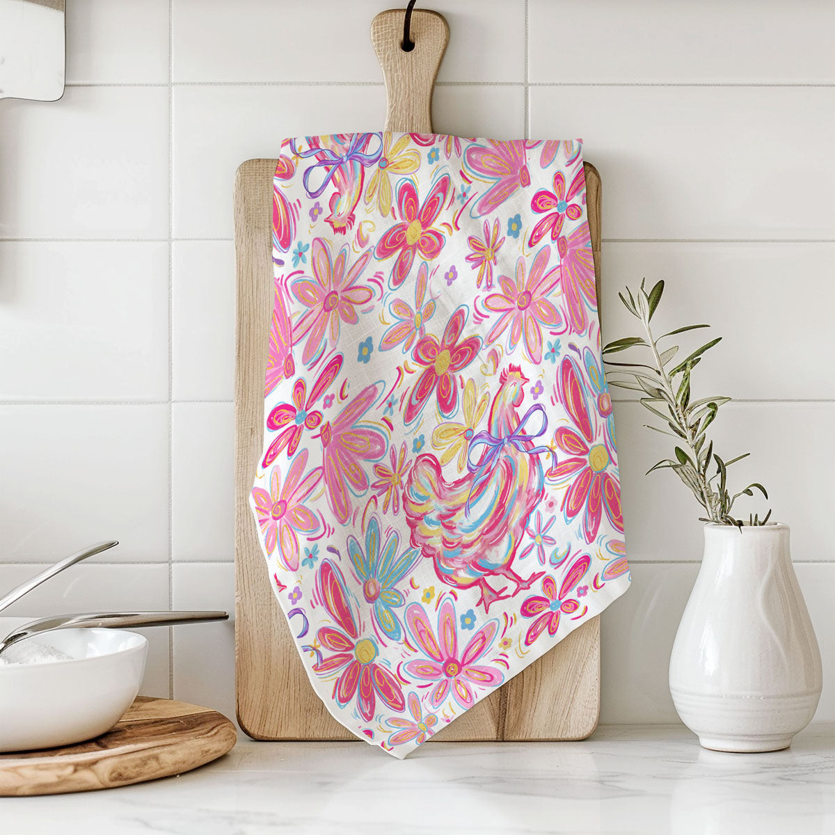 Floral patterned towel on a wooden cutting board in a kitchen setting