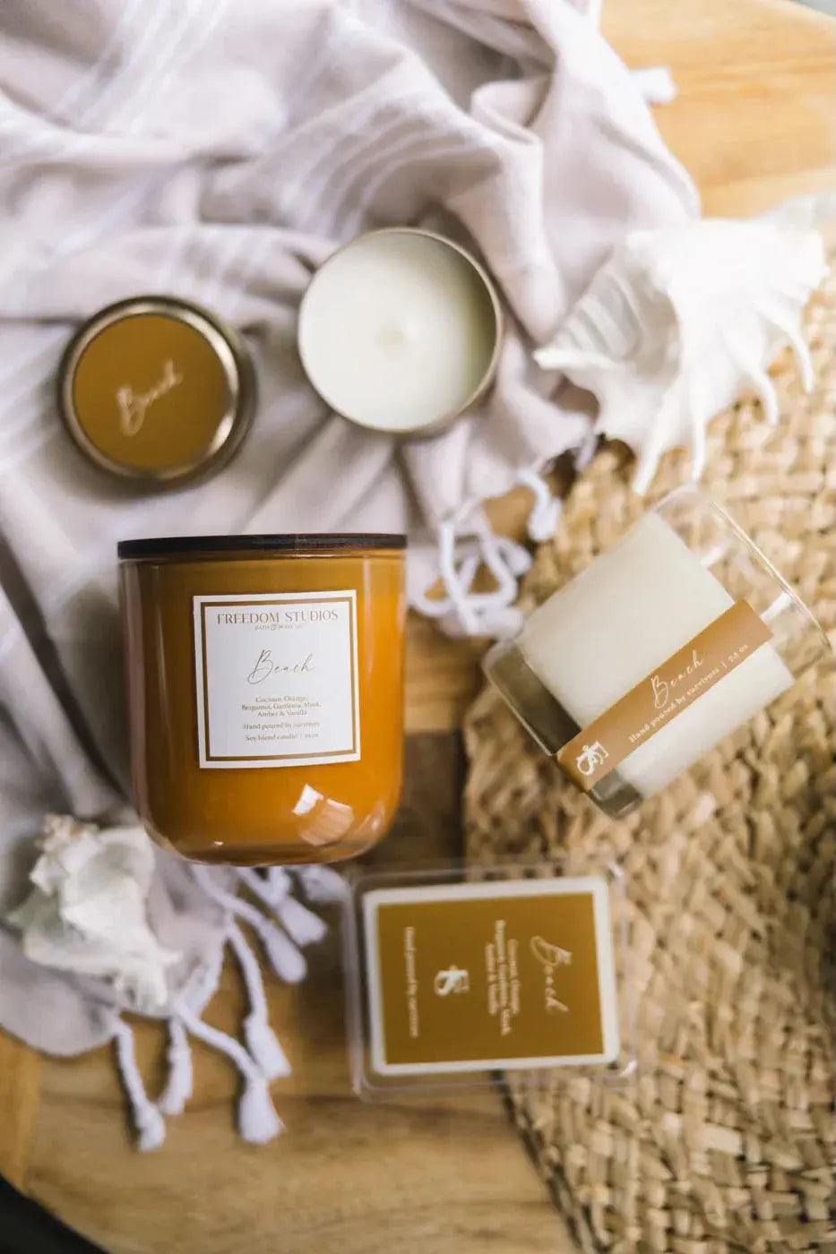 Beach-scented soy candles in amber jars with cozy farmhouse decor, perfect for warm, peaceful home spaces