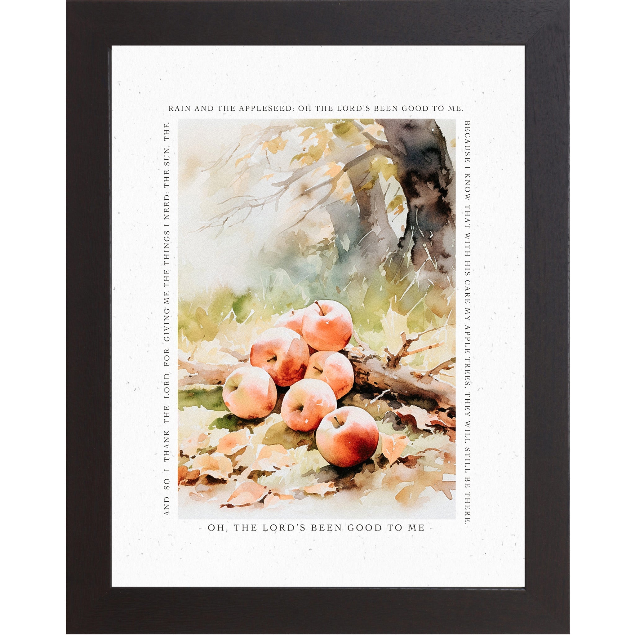 Framed art print featuring a watercolor still life of red apples on the ground with autumn leaves, surrounded by scripture text on a white background with a black frame.