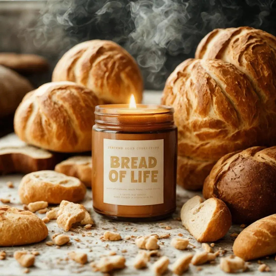 Bread of Life soy candle with warm bakery scent, surrounded by fresh artisan bread for cozy farmhouse decor