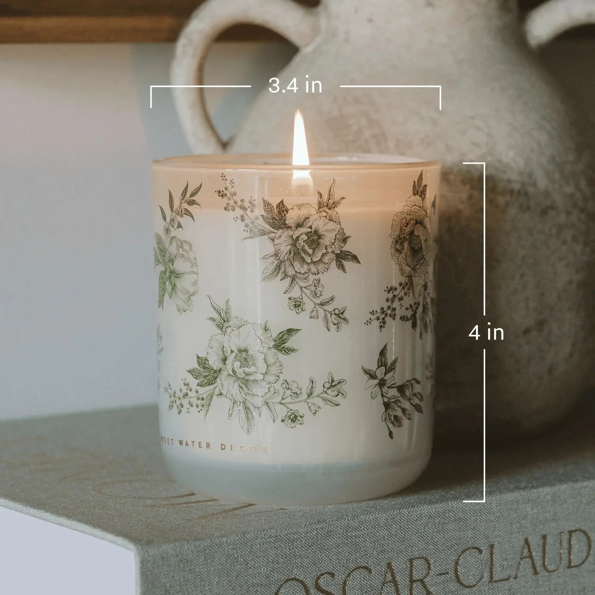 Lit floral candle in farmhouse-style glass jar, cozy home decor with vintage botanical print, 4 inches tall