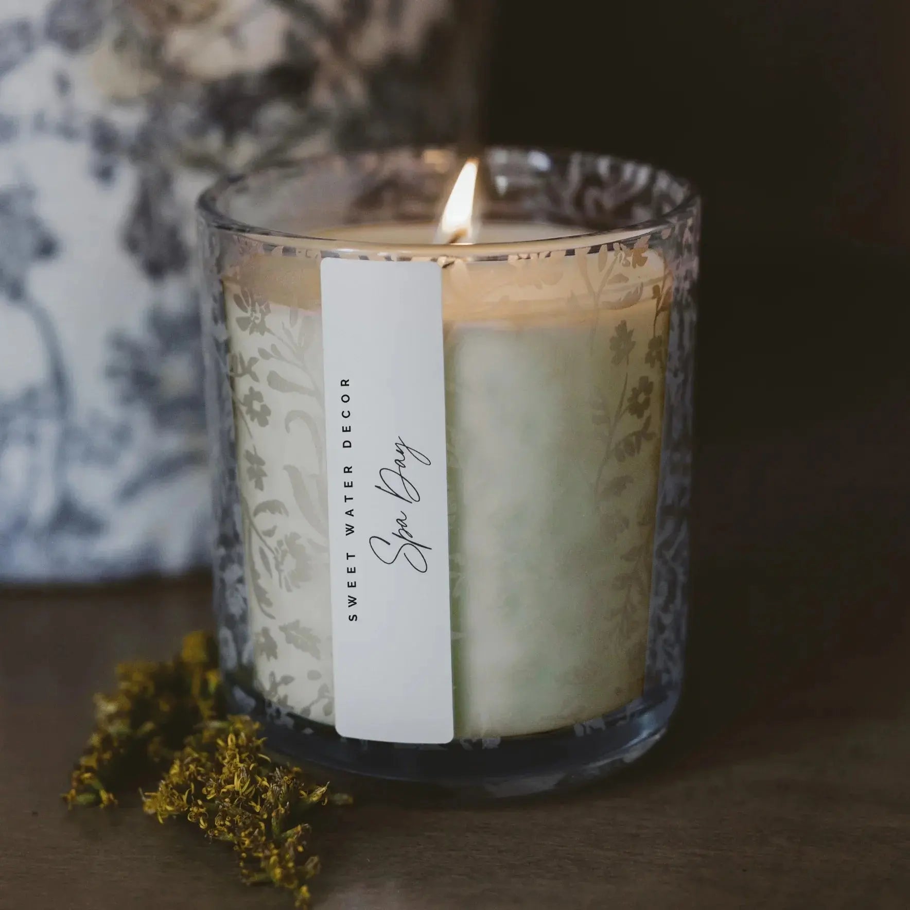 Lit Spa Day candle in floral glass jar, cozy home decor with dried flowers, farmhouse style ambiance