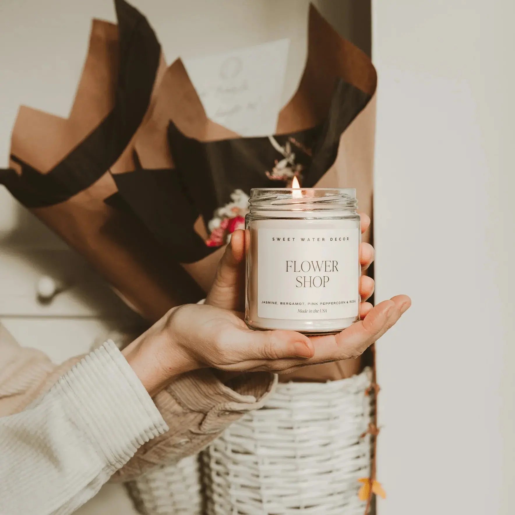 Cozy farmhouse candle labeled Flower Shop, held in hands with gift wrap, perfect for home decor or gifts