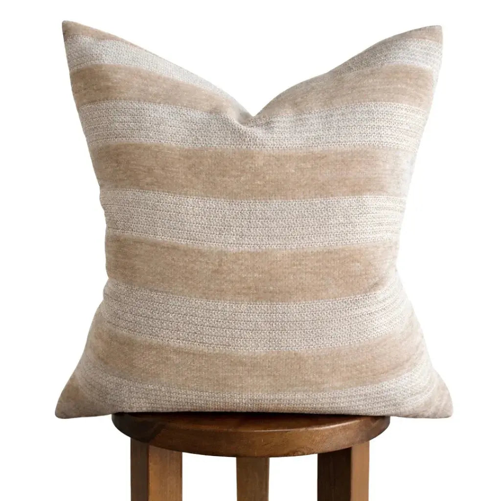 Beige and cream striped throw pillow on wooden stool, cozy farmhouse decor