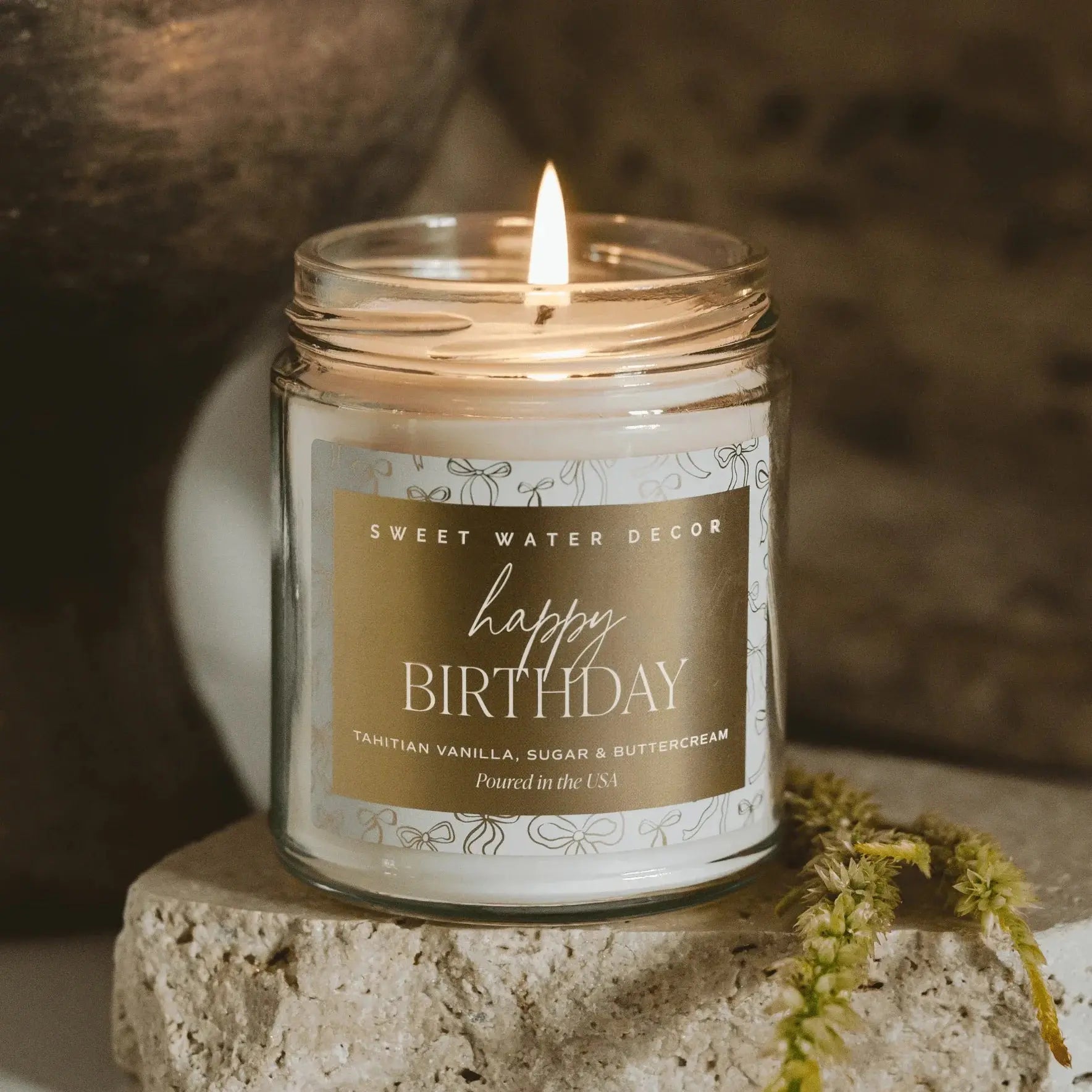 Happy Birthday candle with Tahitian vanilla scent, cozy farmhouse decor, lit in glass jar on stone