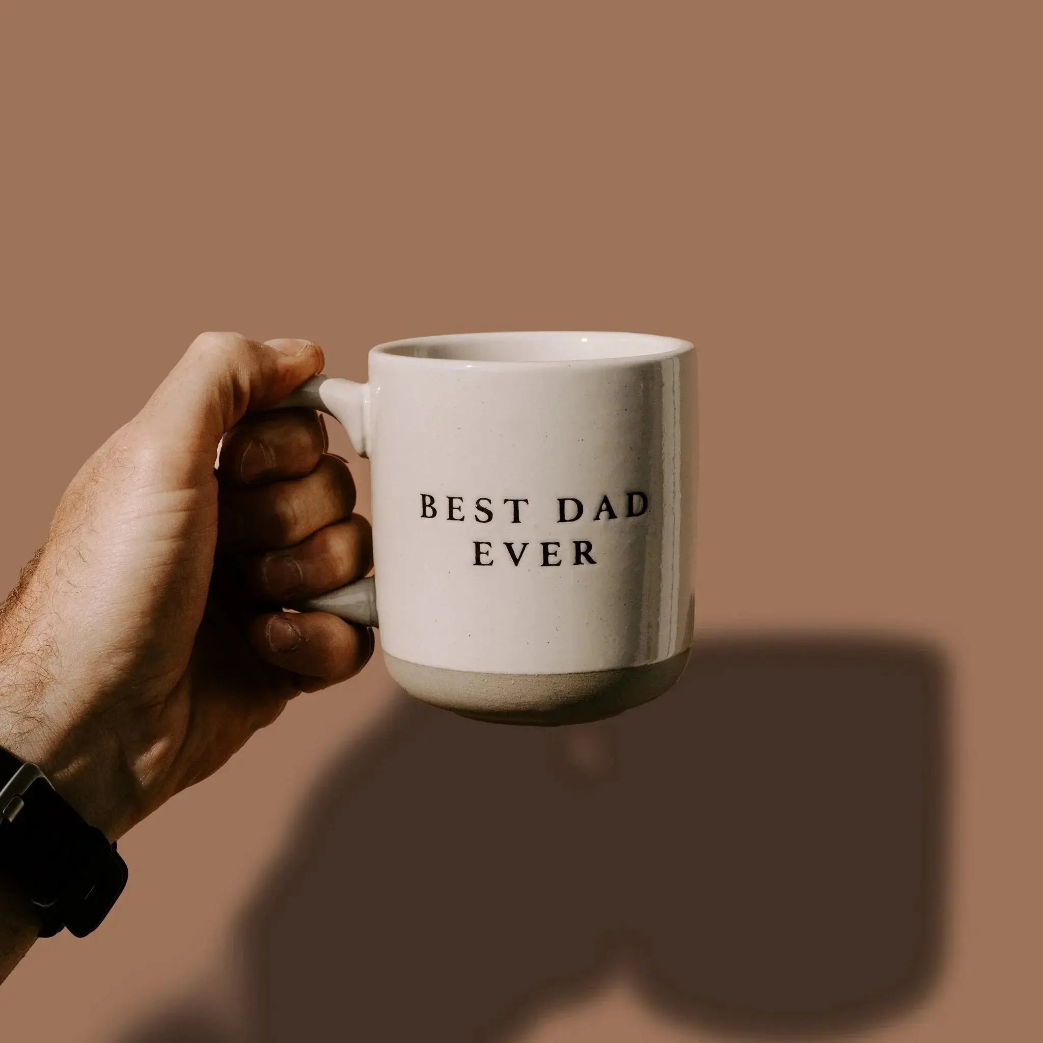 Hand holding white ceramic mug with 'Best Dad Ever' text, cozy farmhouse style gift for fathers