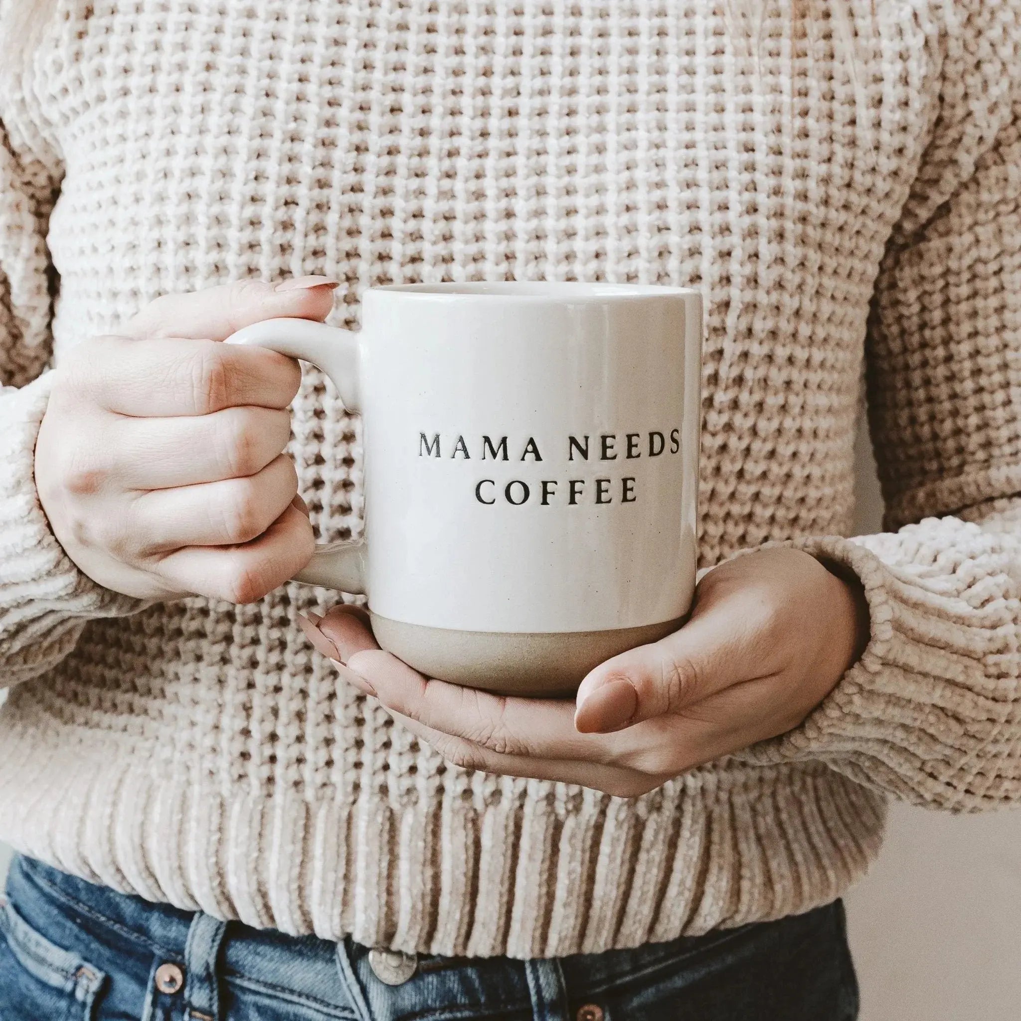 Cozy farmhouse mug with 'Mama Needs Coffee' text, held by woman in knit sweater, perfect for home decor or gifts