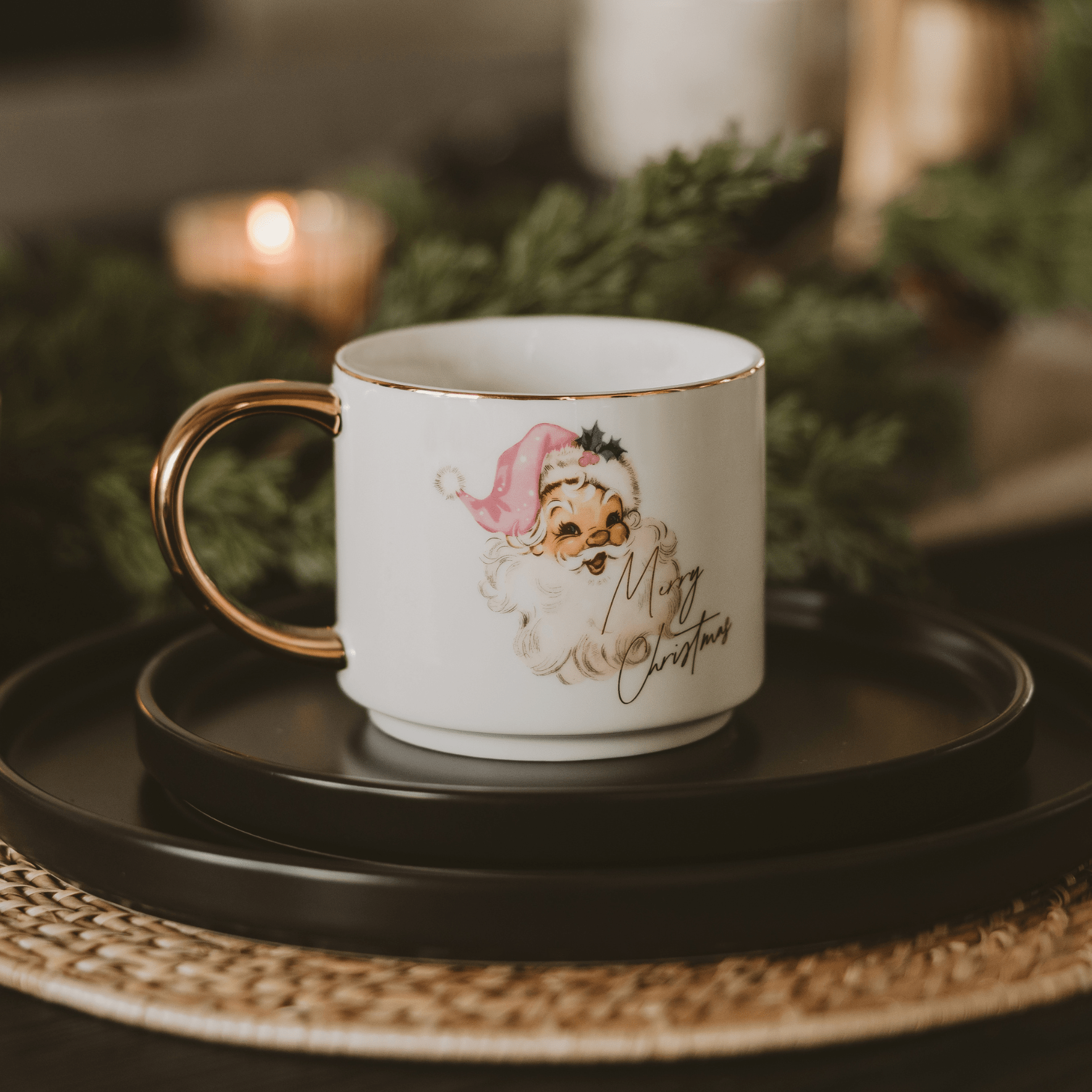 Christmas-themed mug with a decorative design on a black tray.