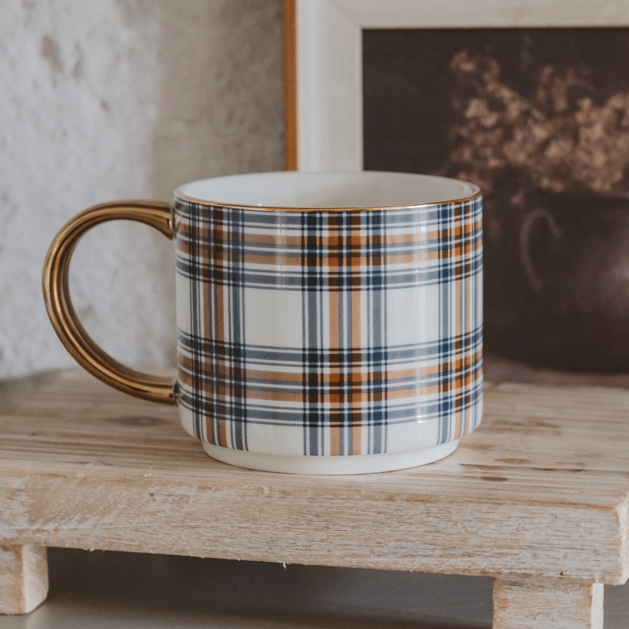 Plaid-patterned mug on a wooden surface with a blurred background