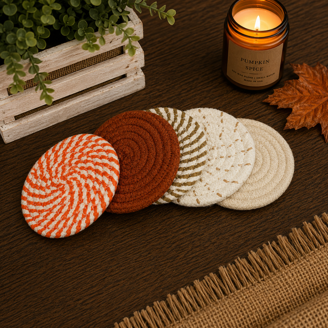 Set of round coasters with different patterns on a wooden surface with a candle and plant in the background.