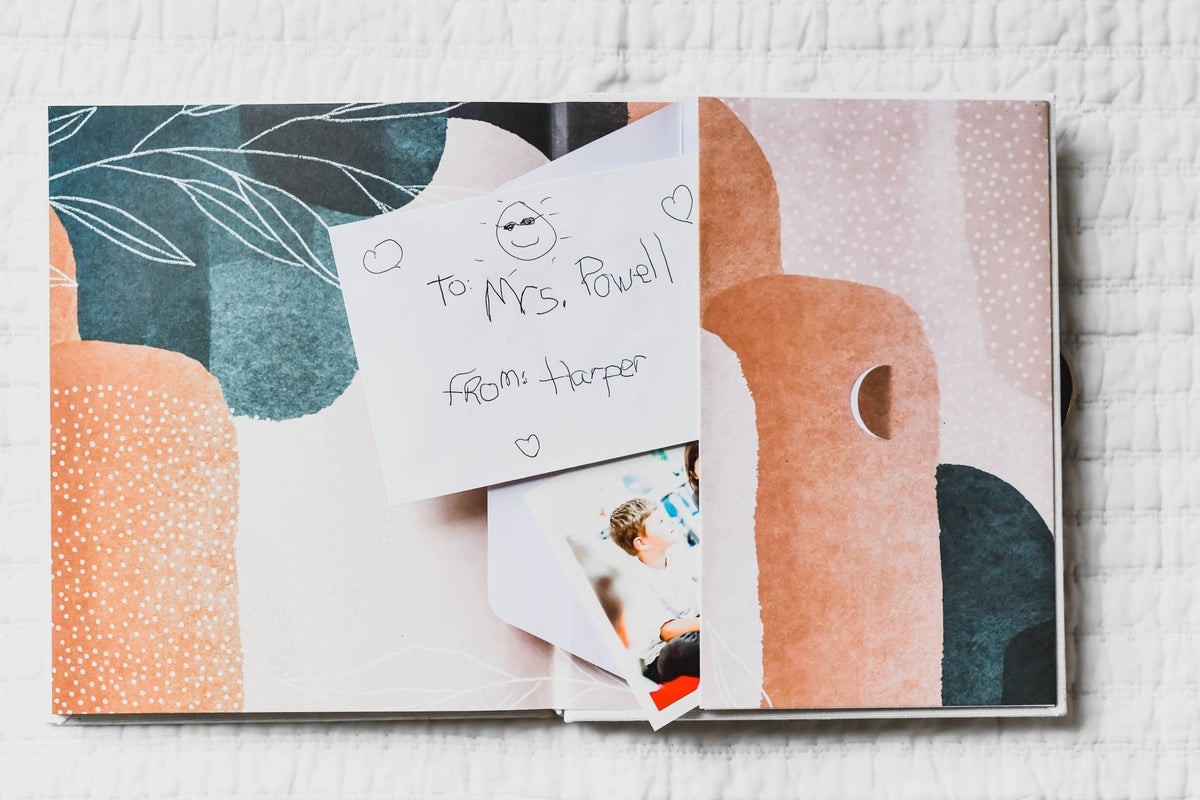 Album with a card and photo inside, on a textured surface