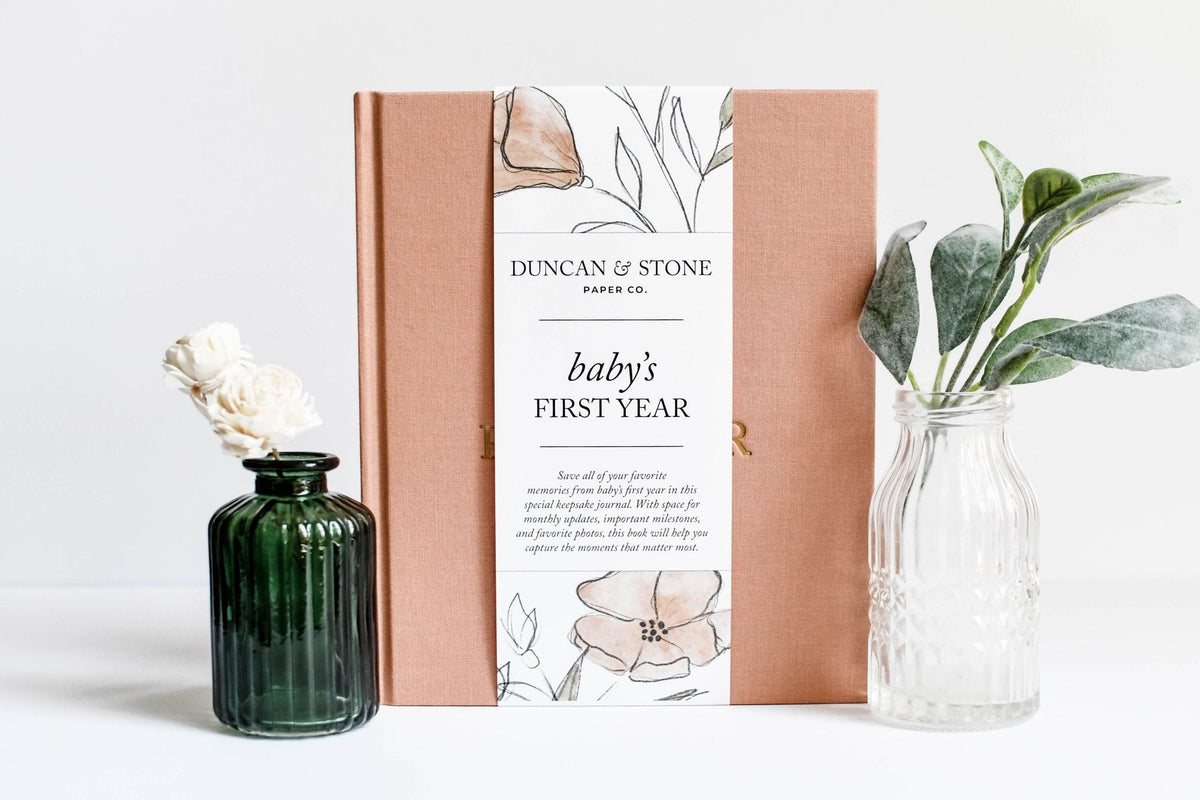 Book titled 'Baby's First Year' by Duncan & Stone with decorative vases on a white background