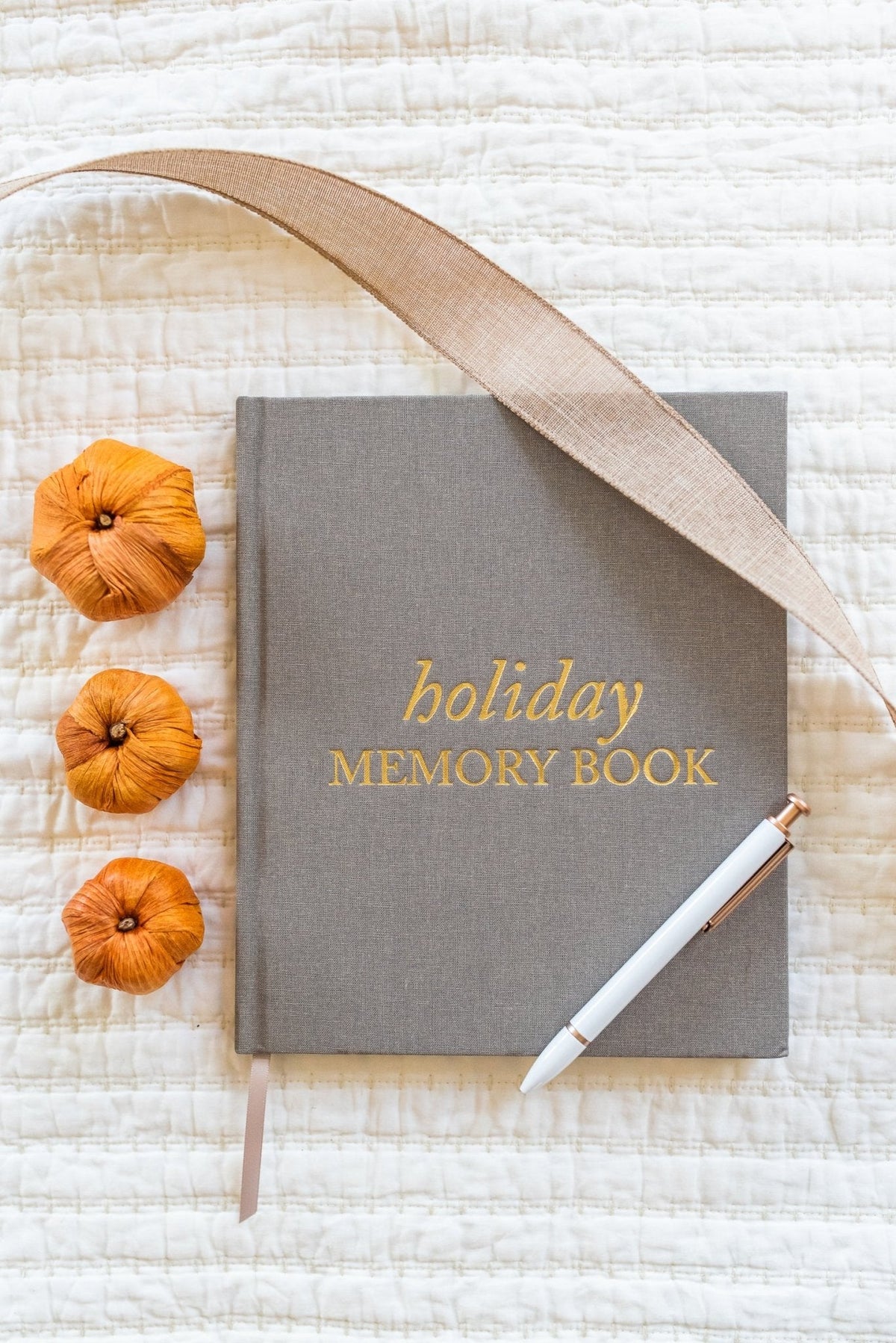 holiday memory book by Duncan & Stone with a silk sash, a pin, and small pumpkins