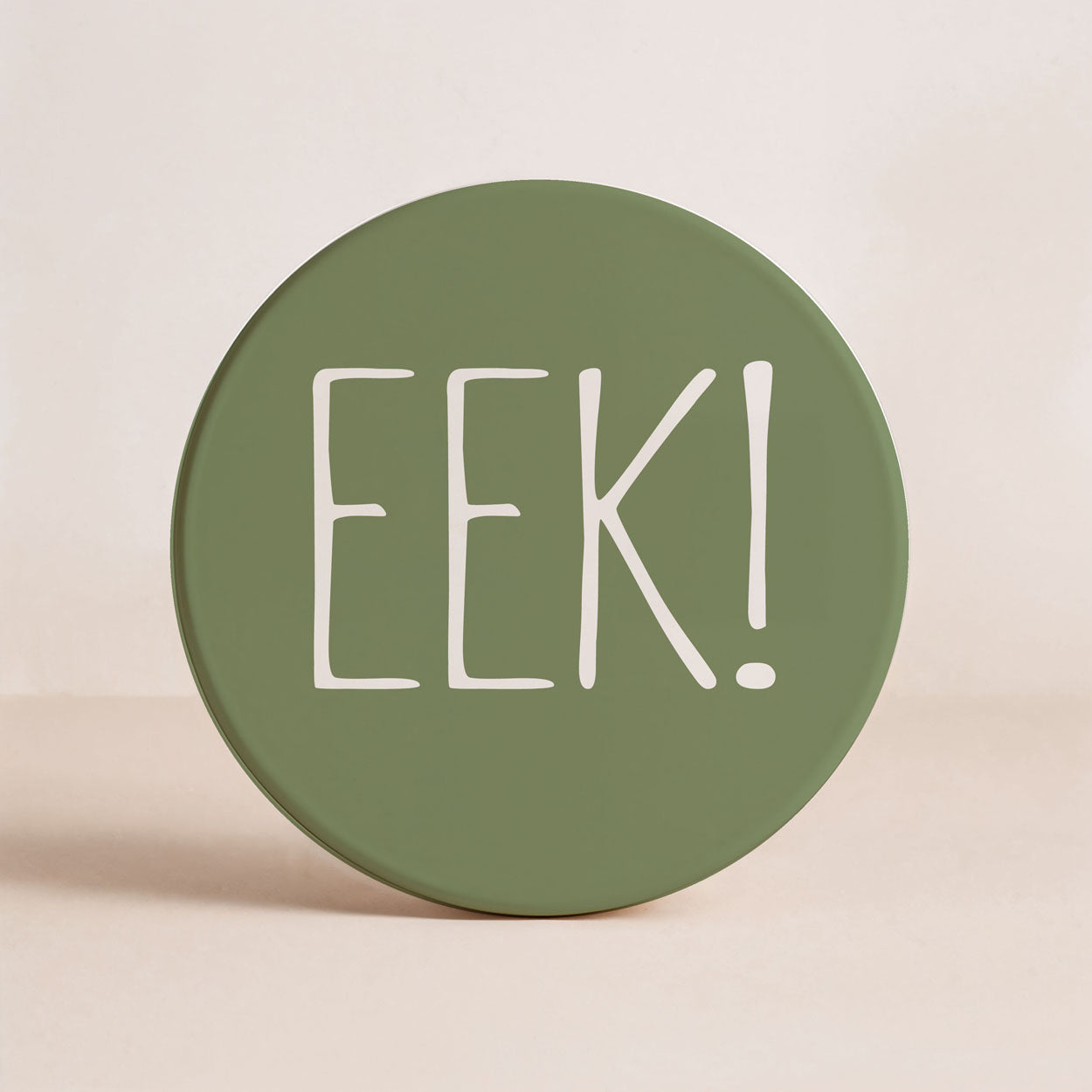 Green round container with 'EEK!' text on a beige background
